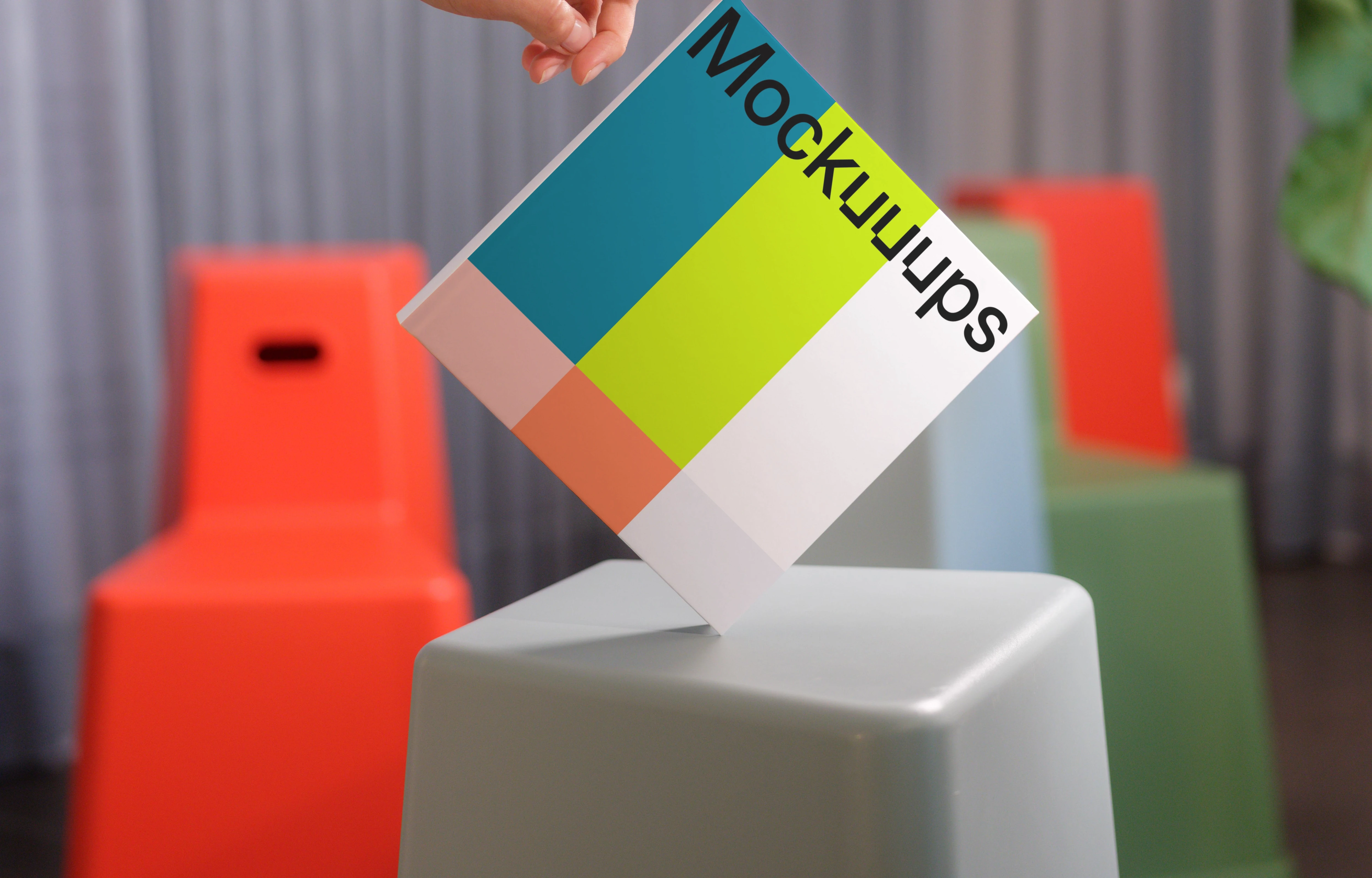 Hand-held square book mockup with modern seating