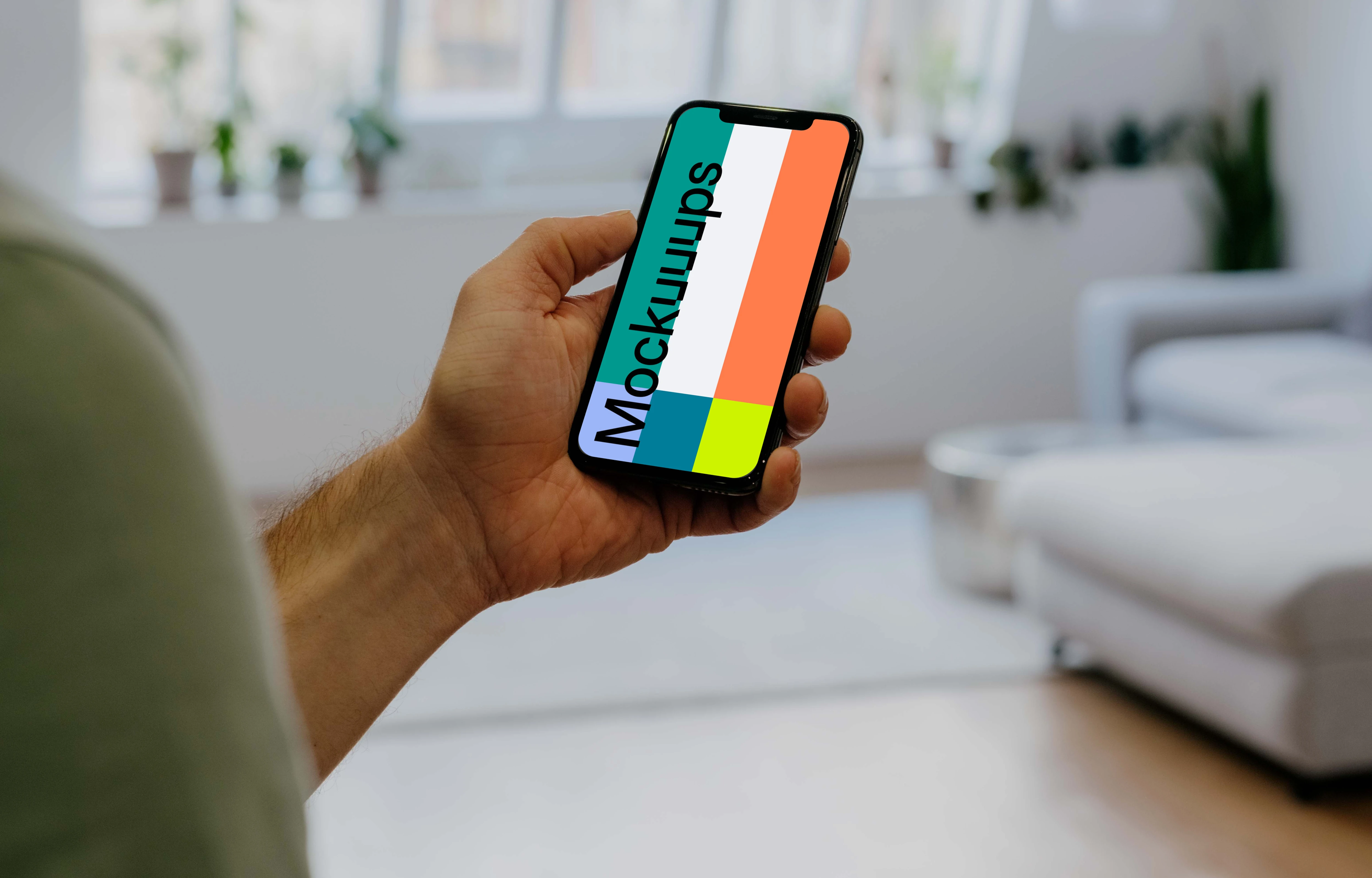 Holding iPhone 12 Pro Mockup in front of windows