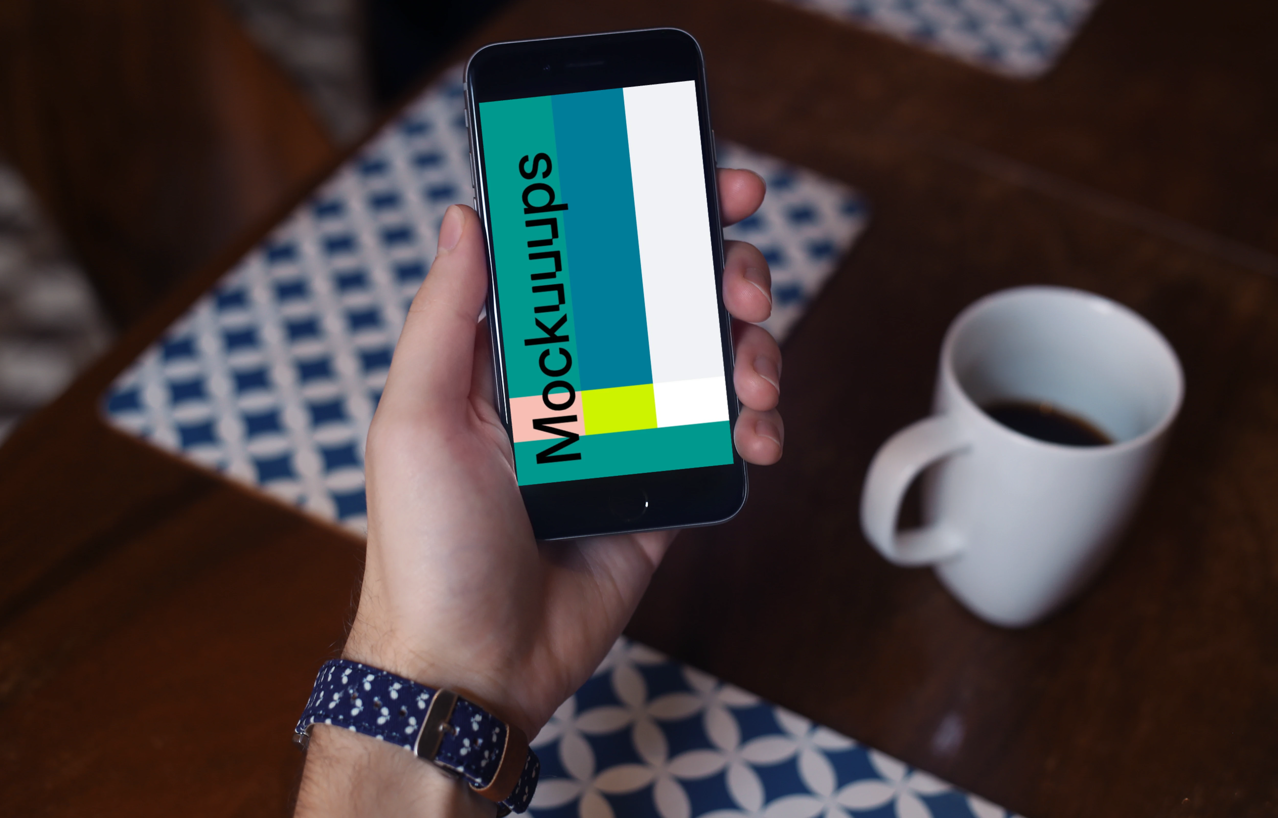 Holding iPhone 6 mockup and drinking coffee