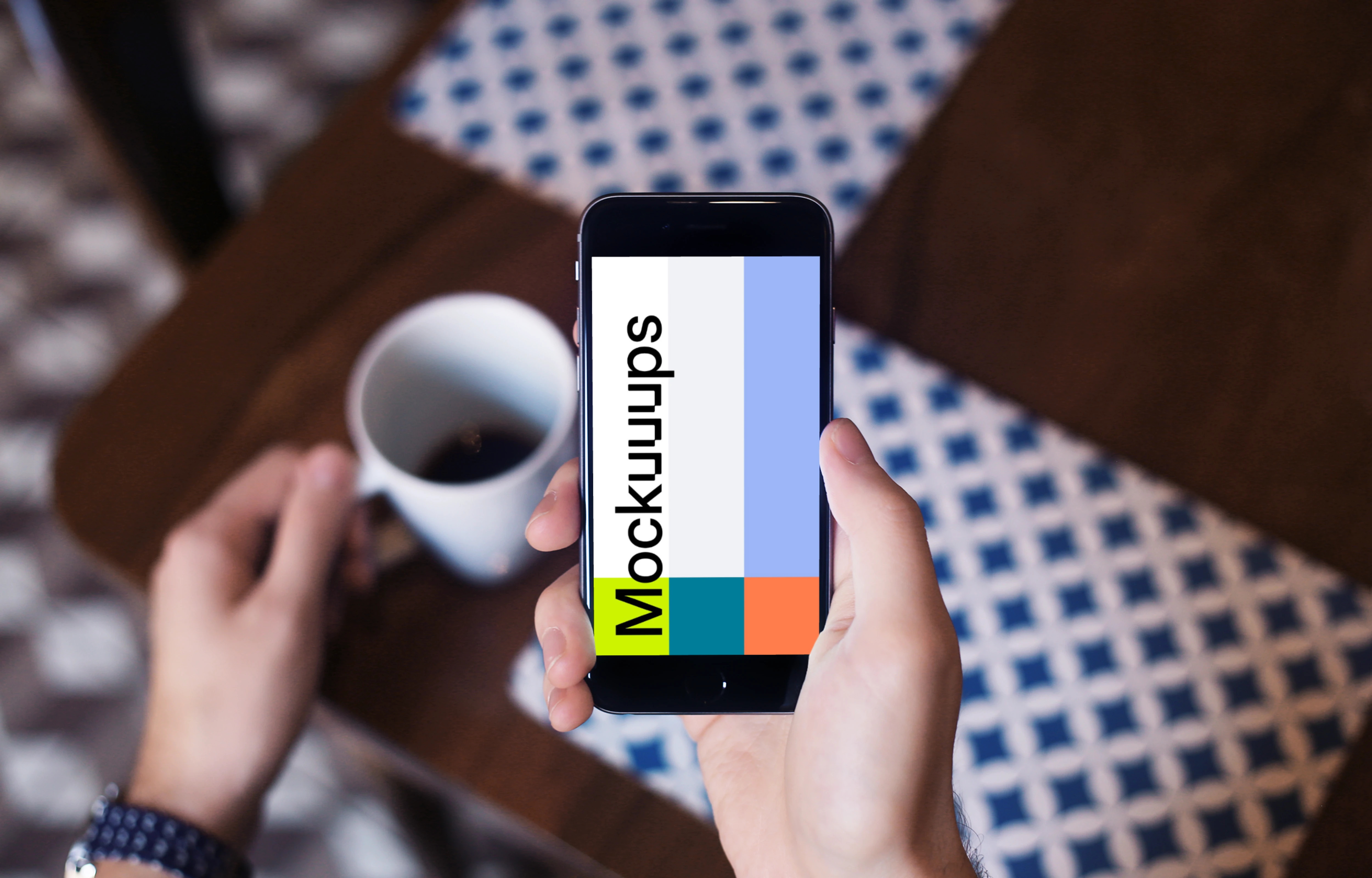 Holding iPhone 6 mockup and drinking coffee