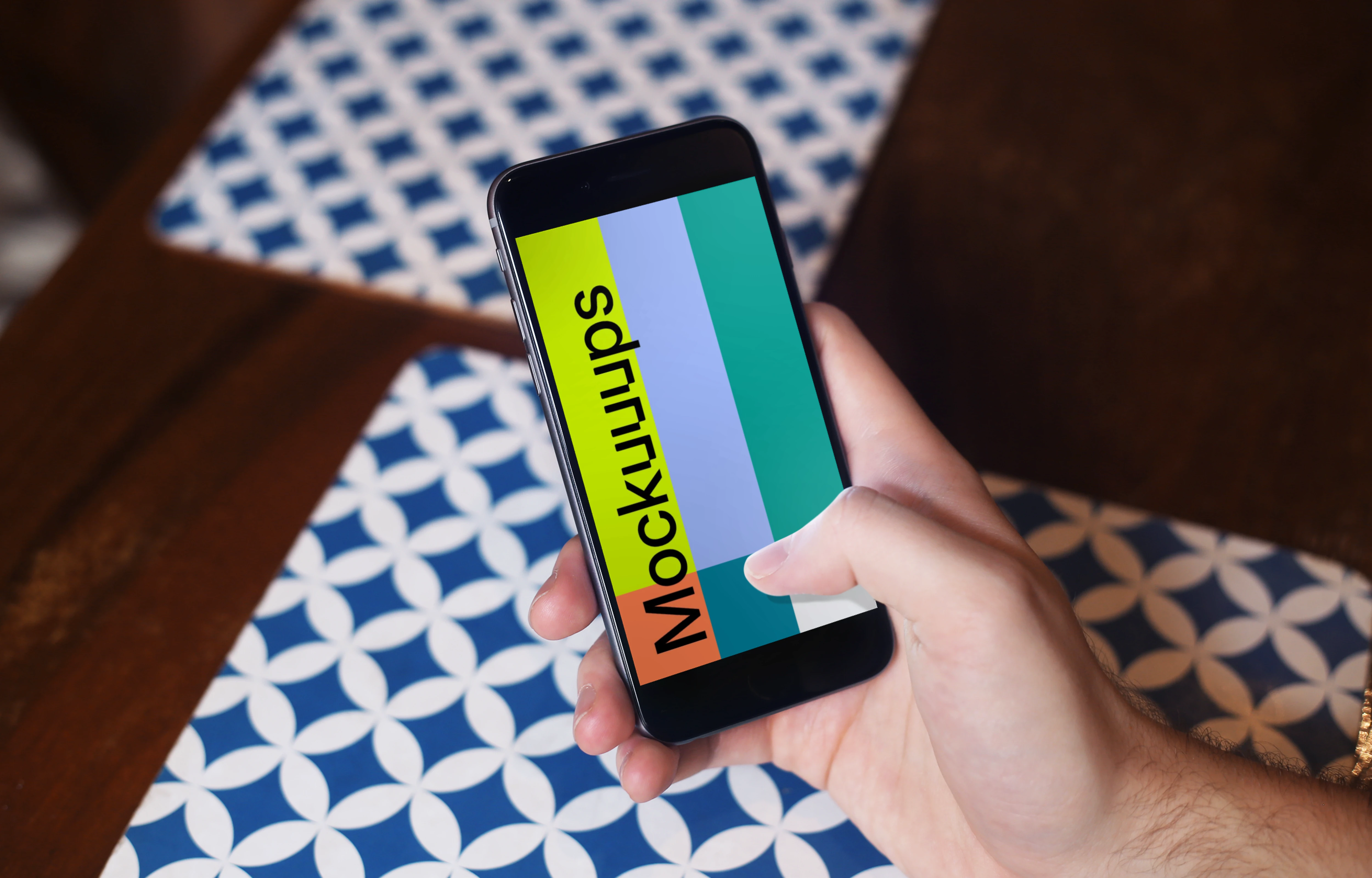 Holding iPhone 6 mockup at coffee