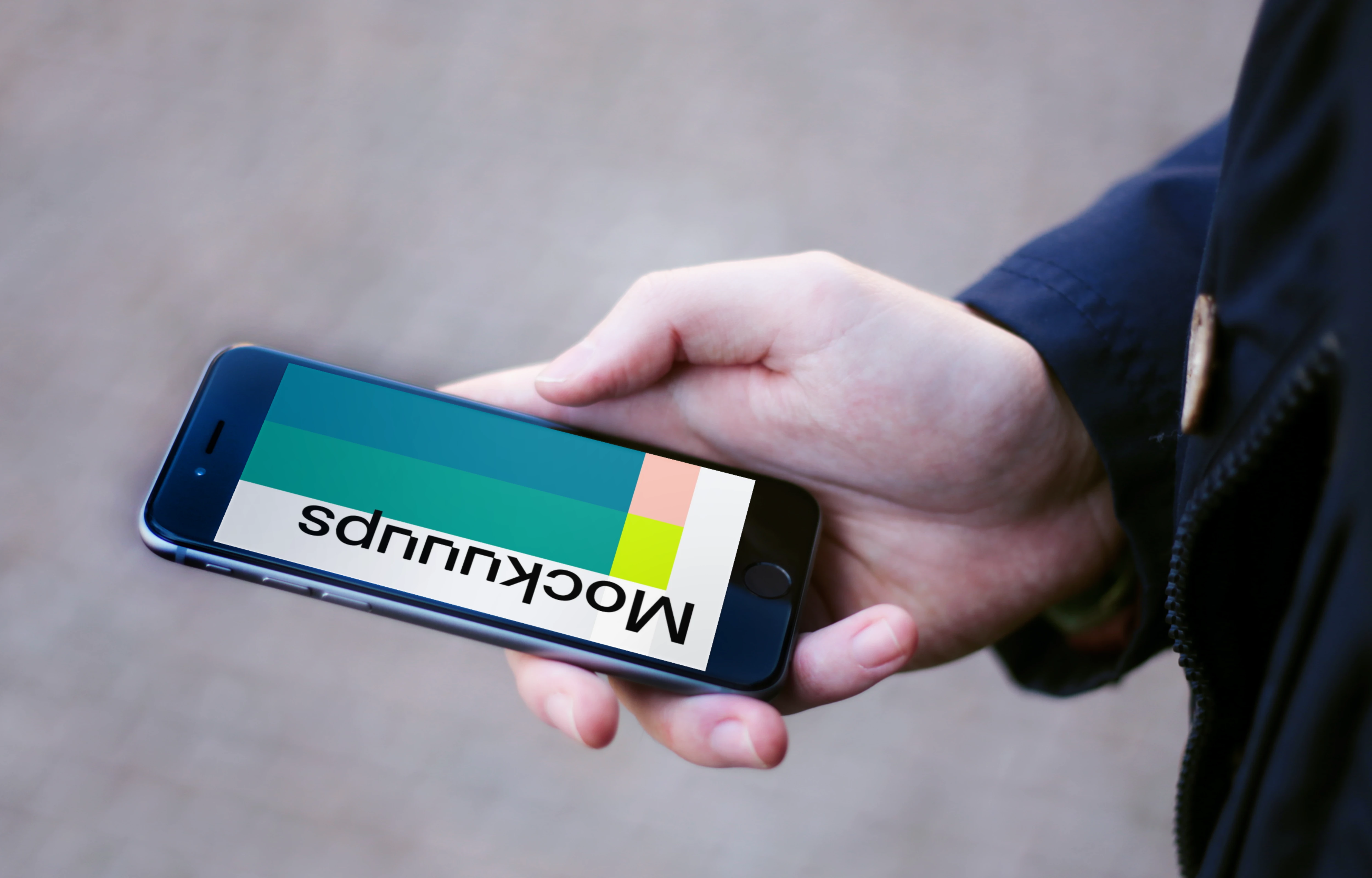 Holding iPhone 6 mockup on the street