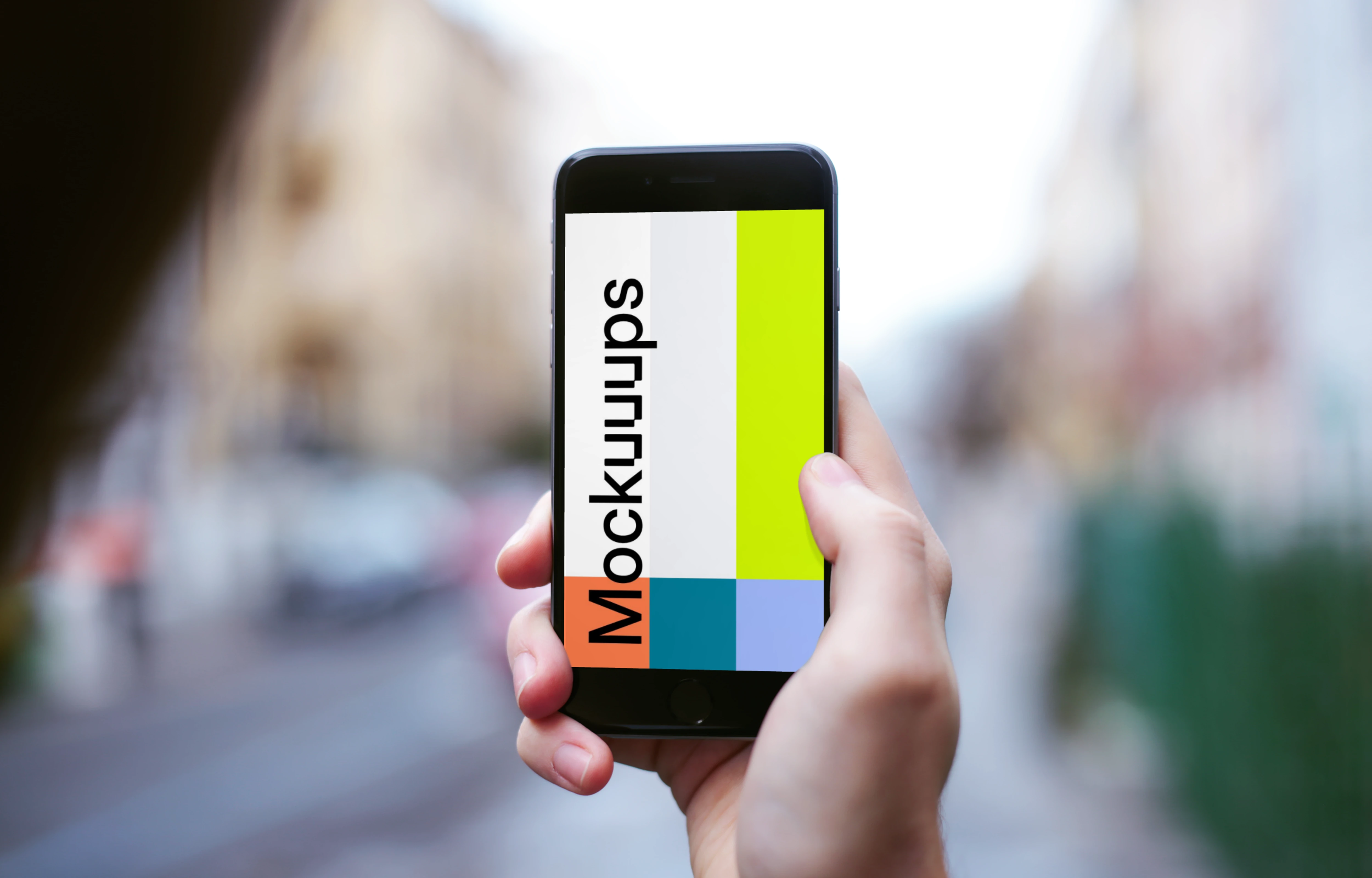 Holding iPhone 6 mockup on the street