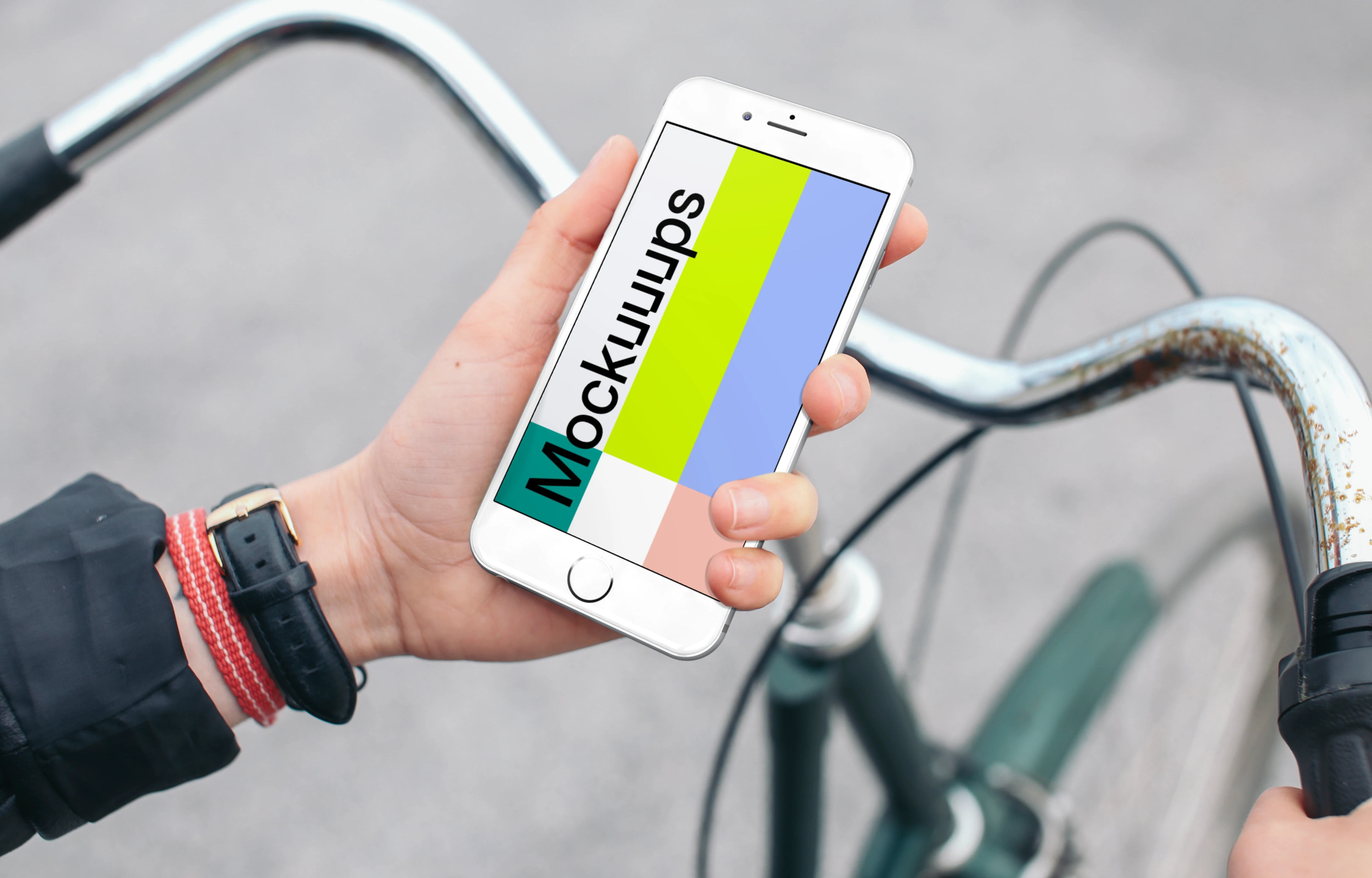 Holding iPhone 6s mockup on a Bike
