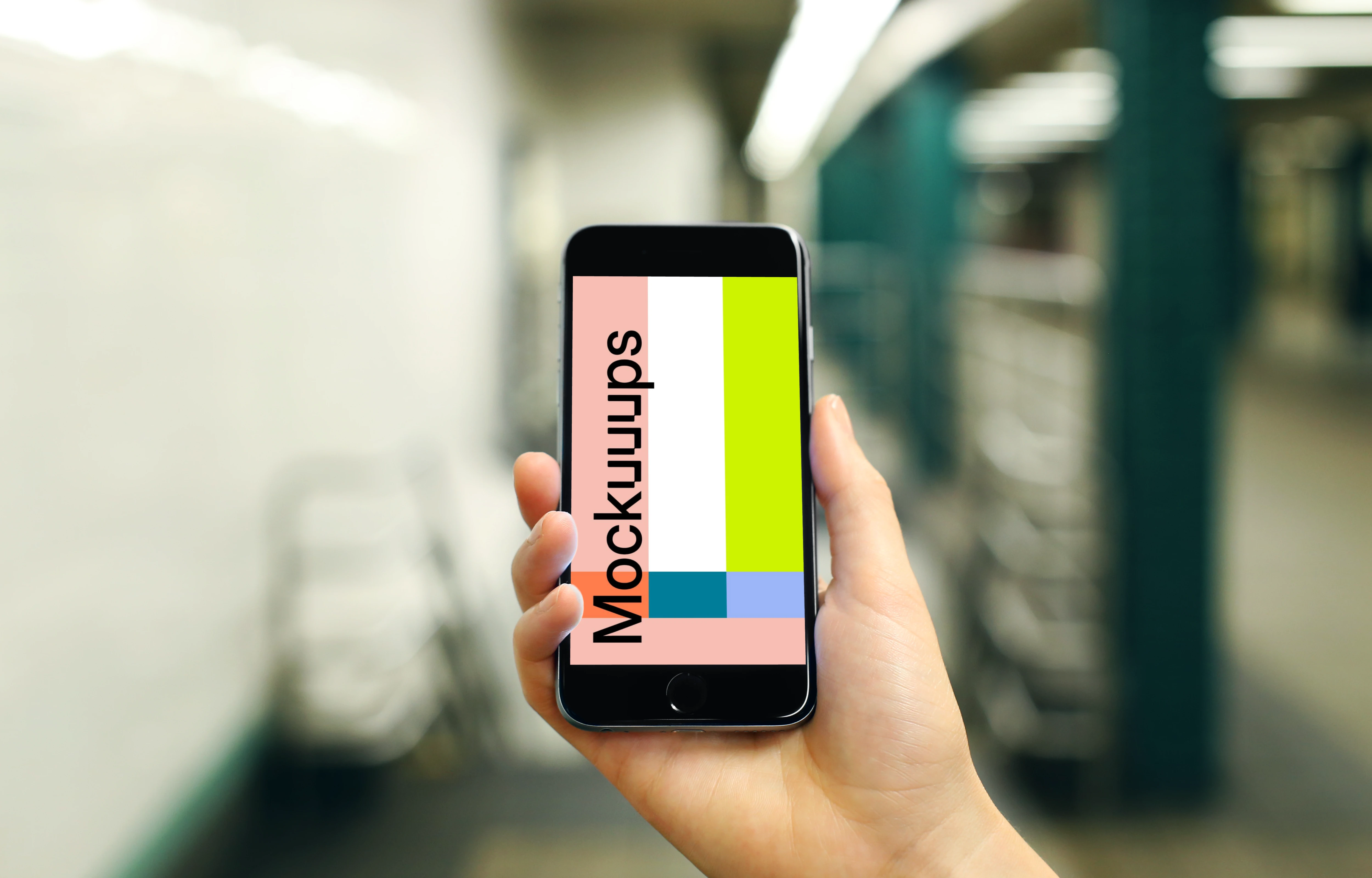 Holding iPhone 6s mockup on a Train Station