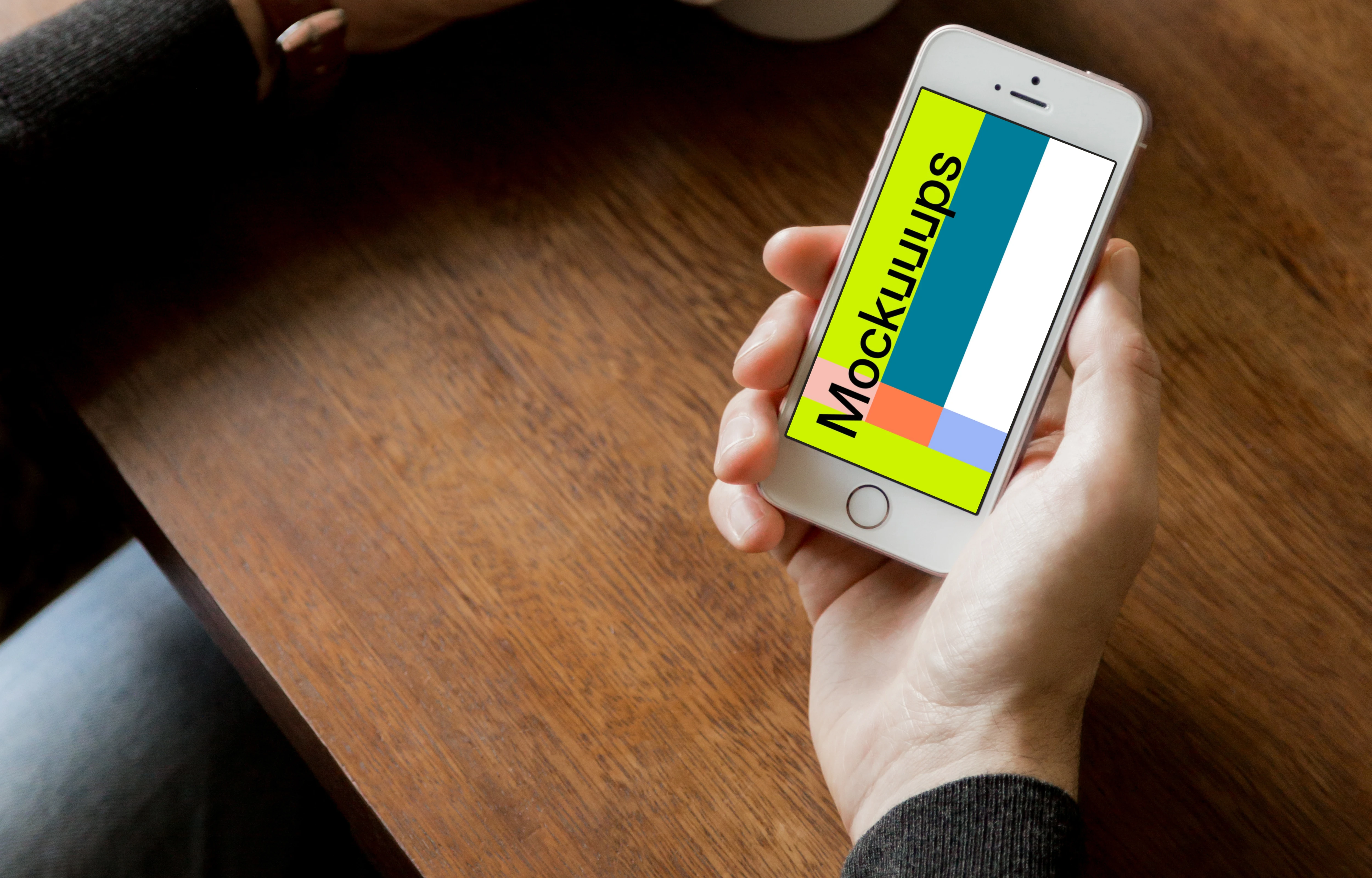 Holding iPhone SE mockup and drinking black coffee