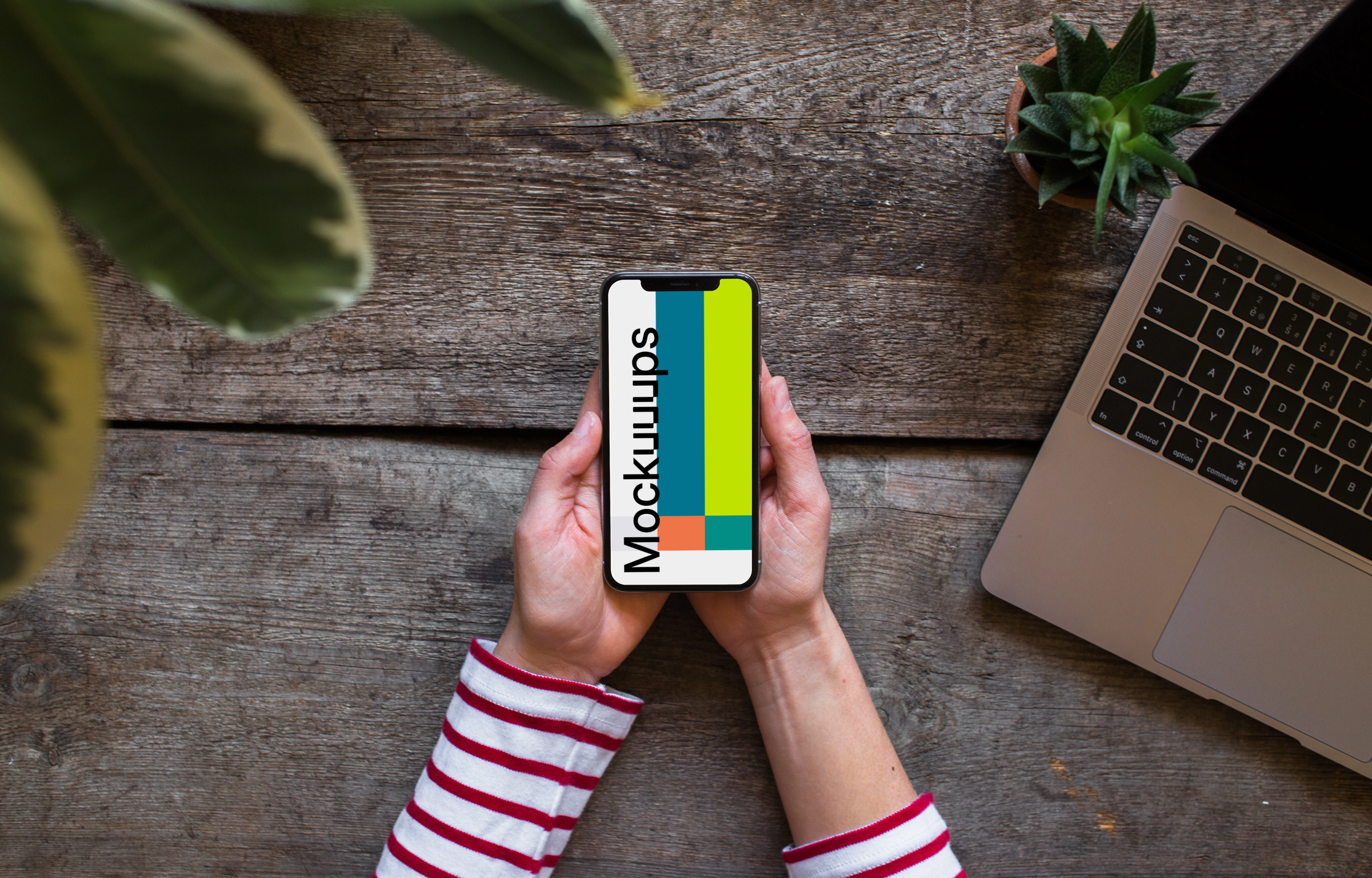 Holding iPhone XS mockup with both hands