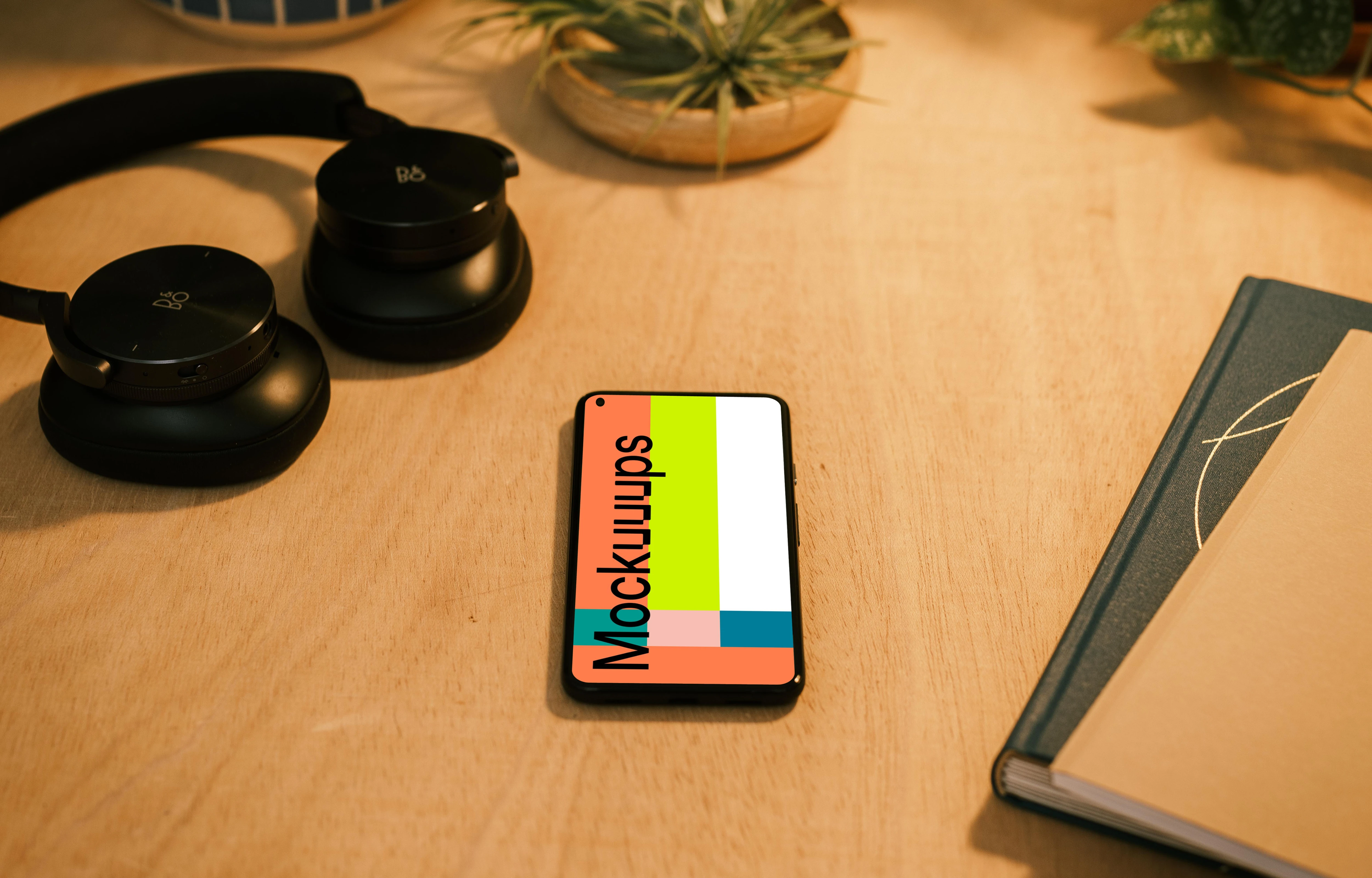 Google Pixel 5 mockup with a pair of headphones at the side