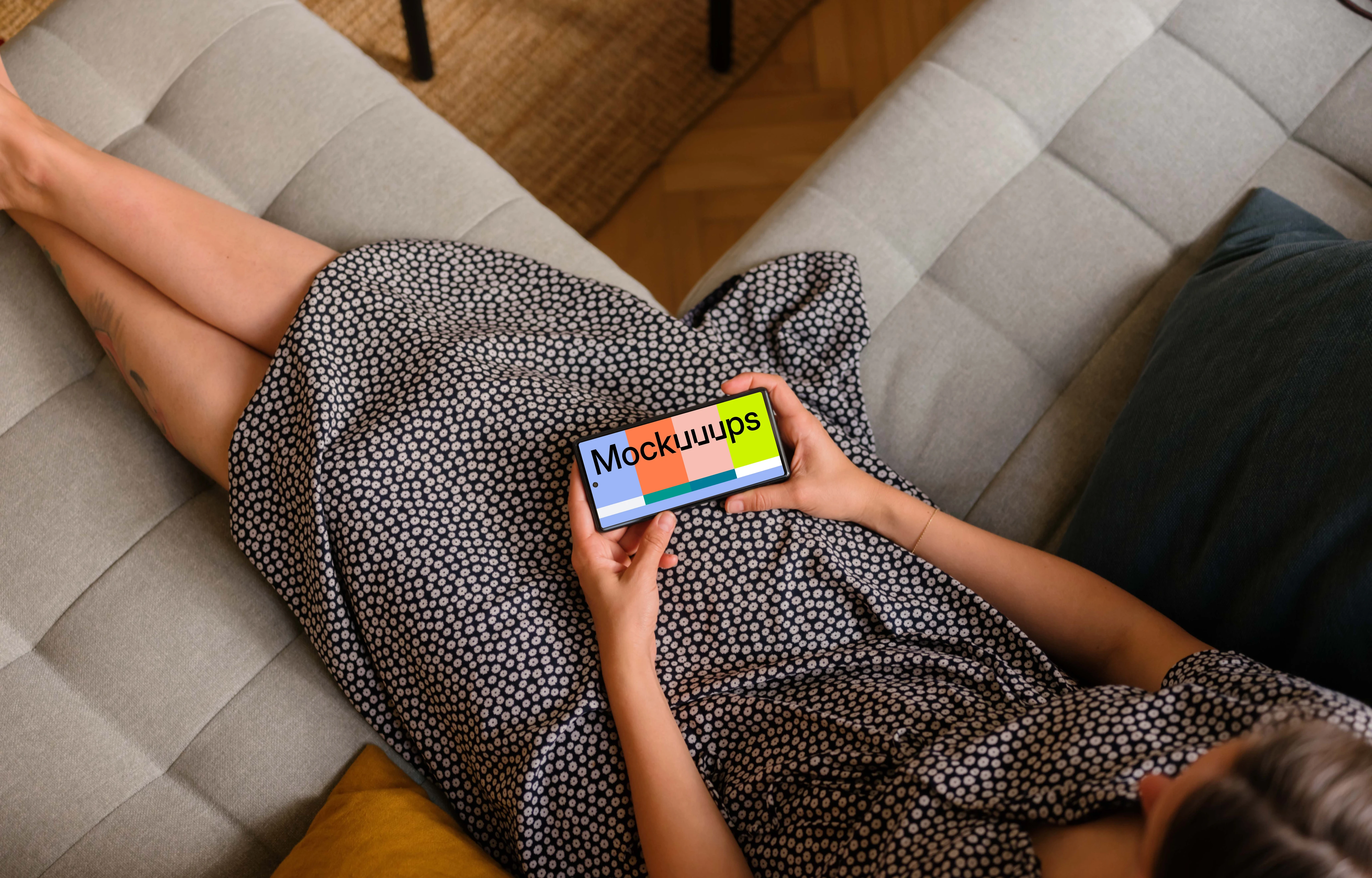 Woman laying on sofa holding a Google Pixel 6 mockup