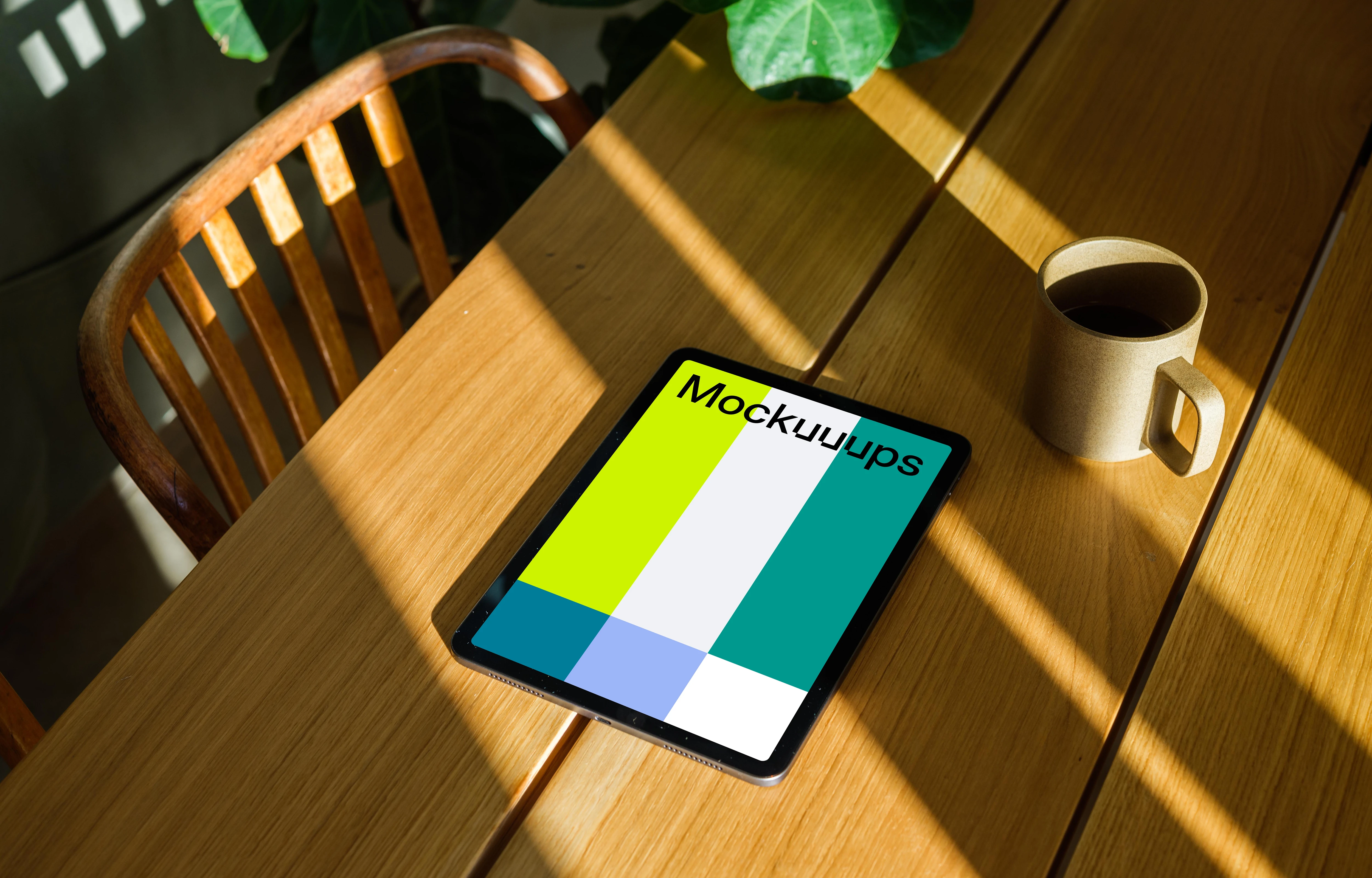 iPad Air mockup beside a cup of coffee and a plant in the background