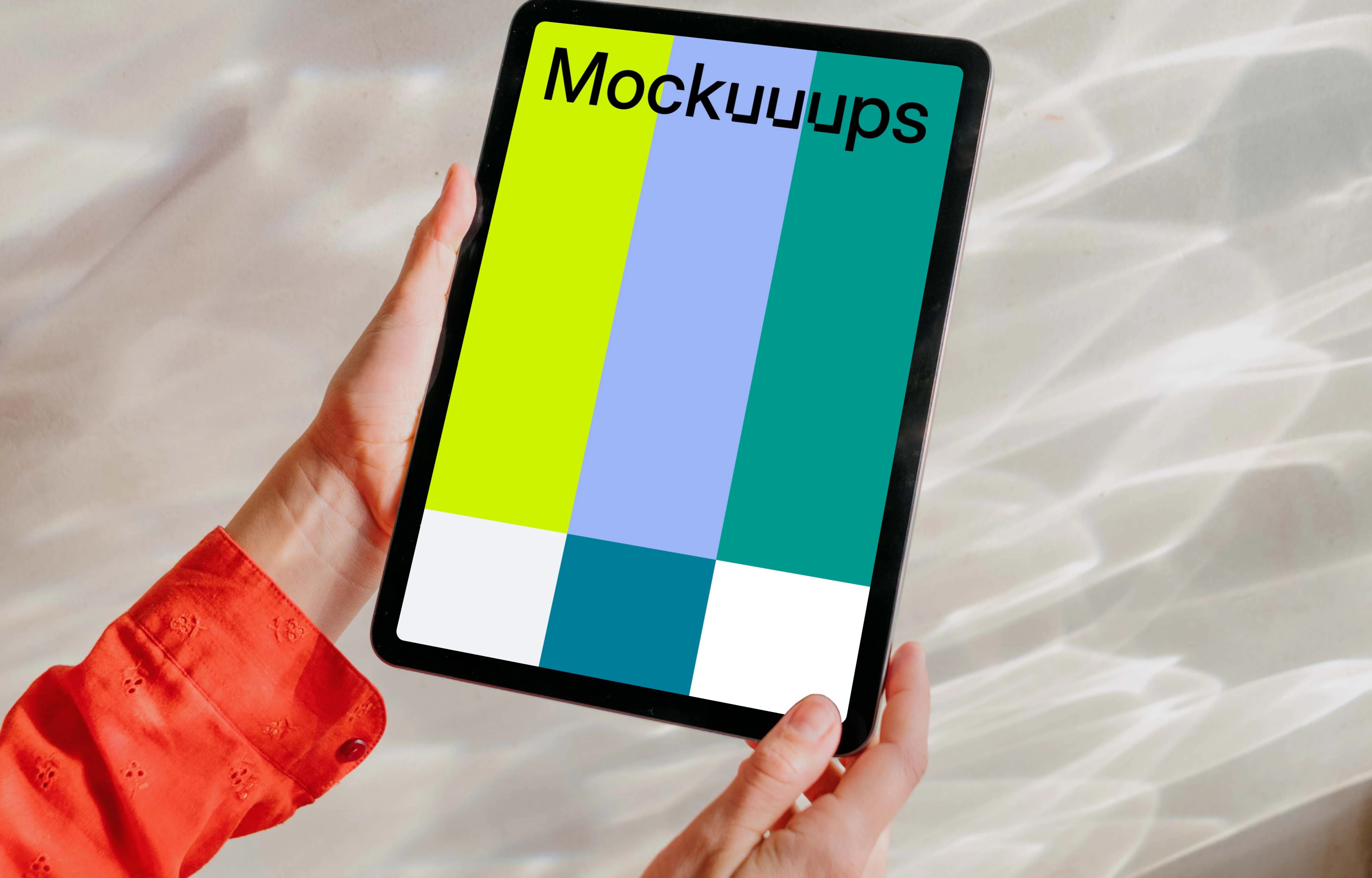Free iPad Air mockup held by user against a bright silver background 