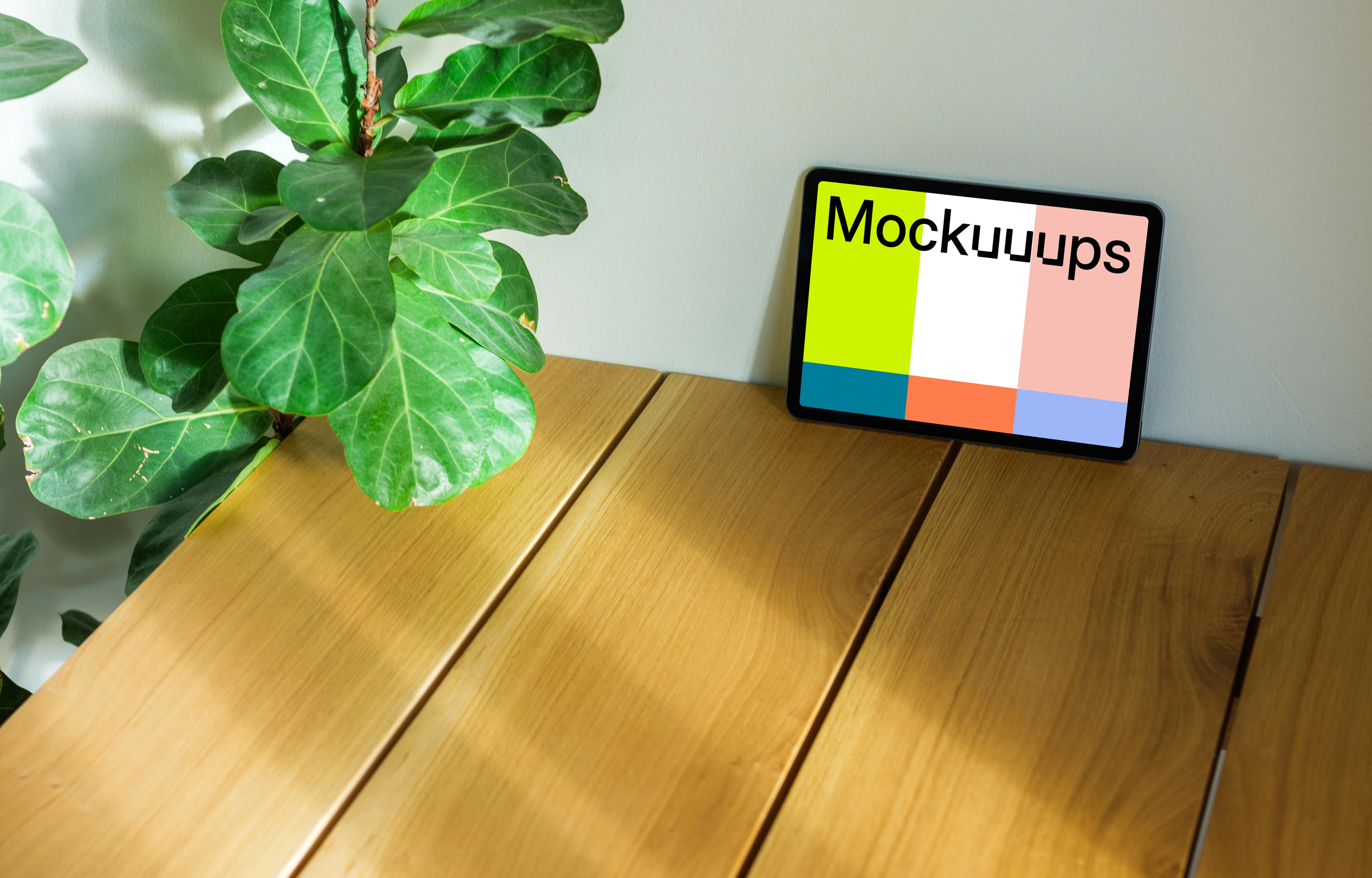 iPad Air mockup leaning on a wall beside a plant