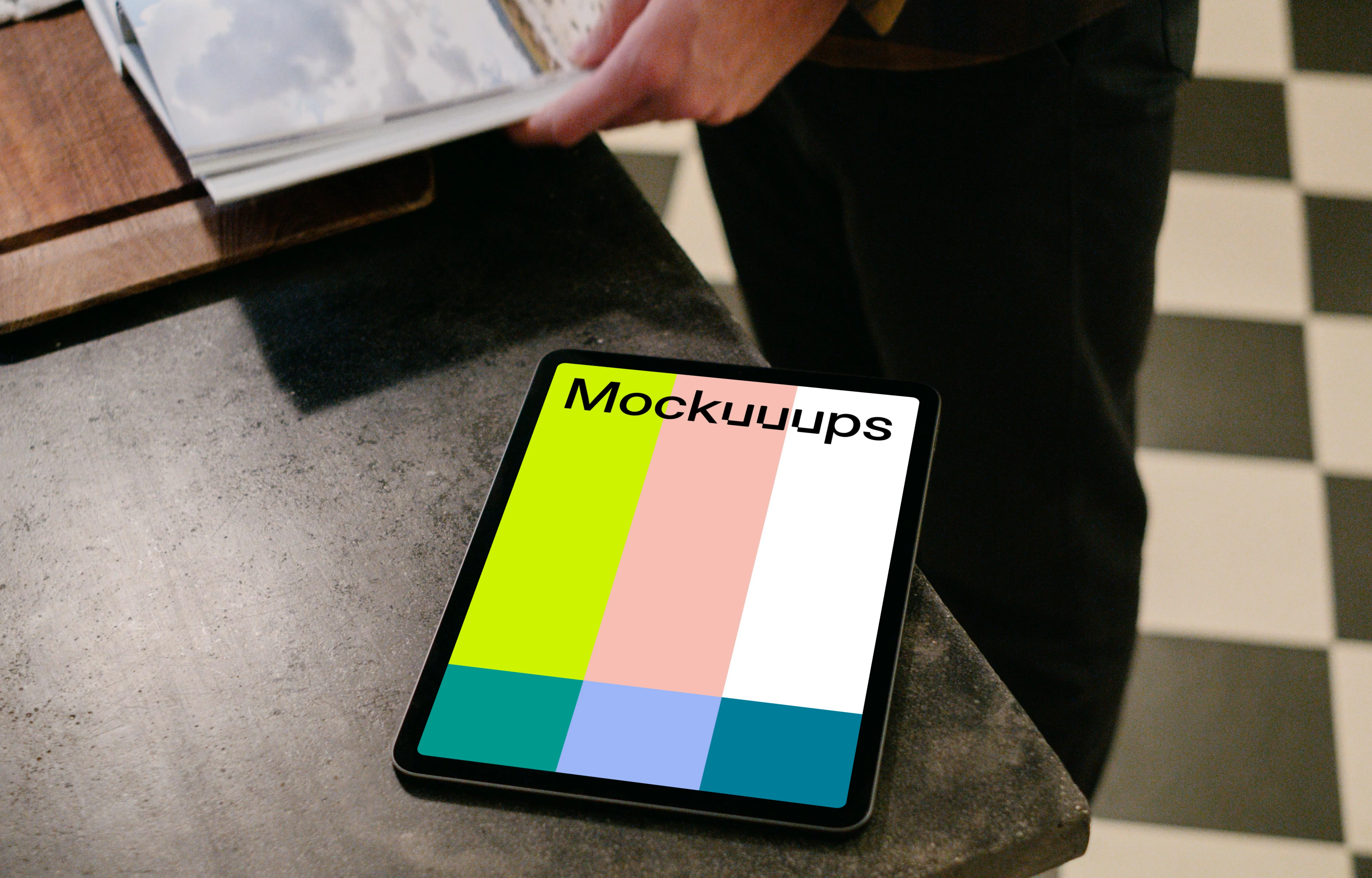 iPad Air mockup on a black table next to a user