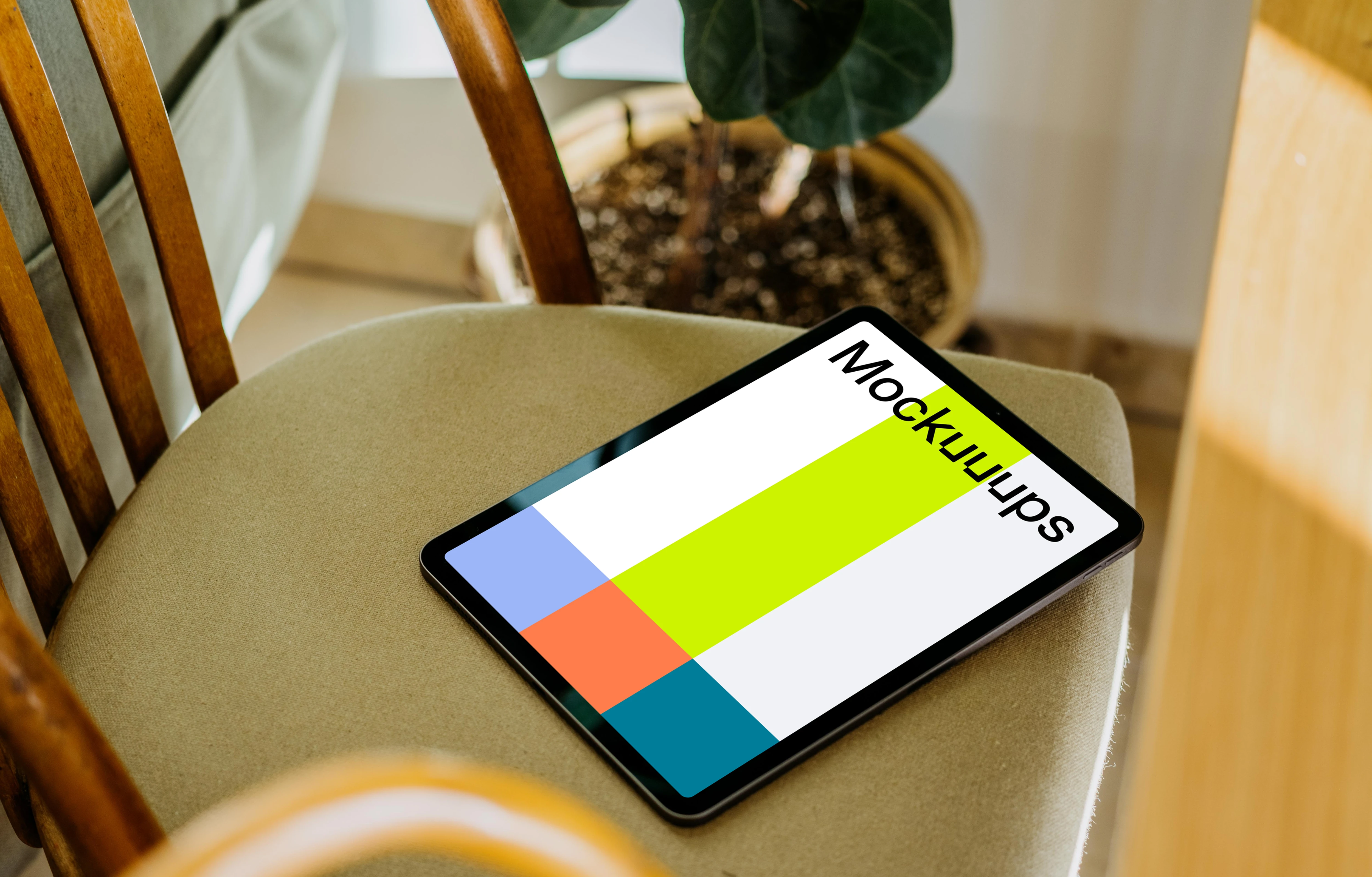 iPad Air mockup on a chair with a plant in the background