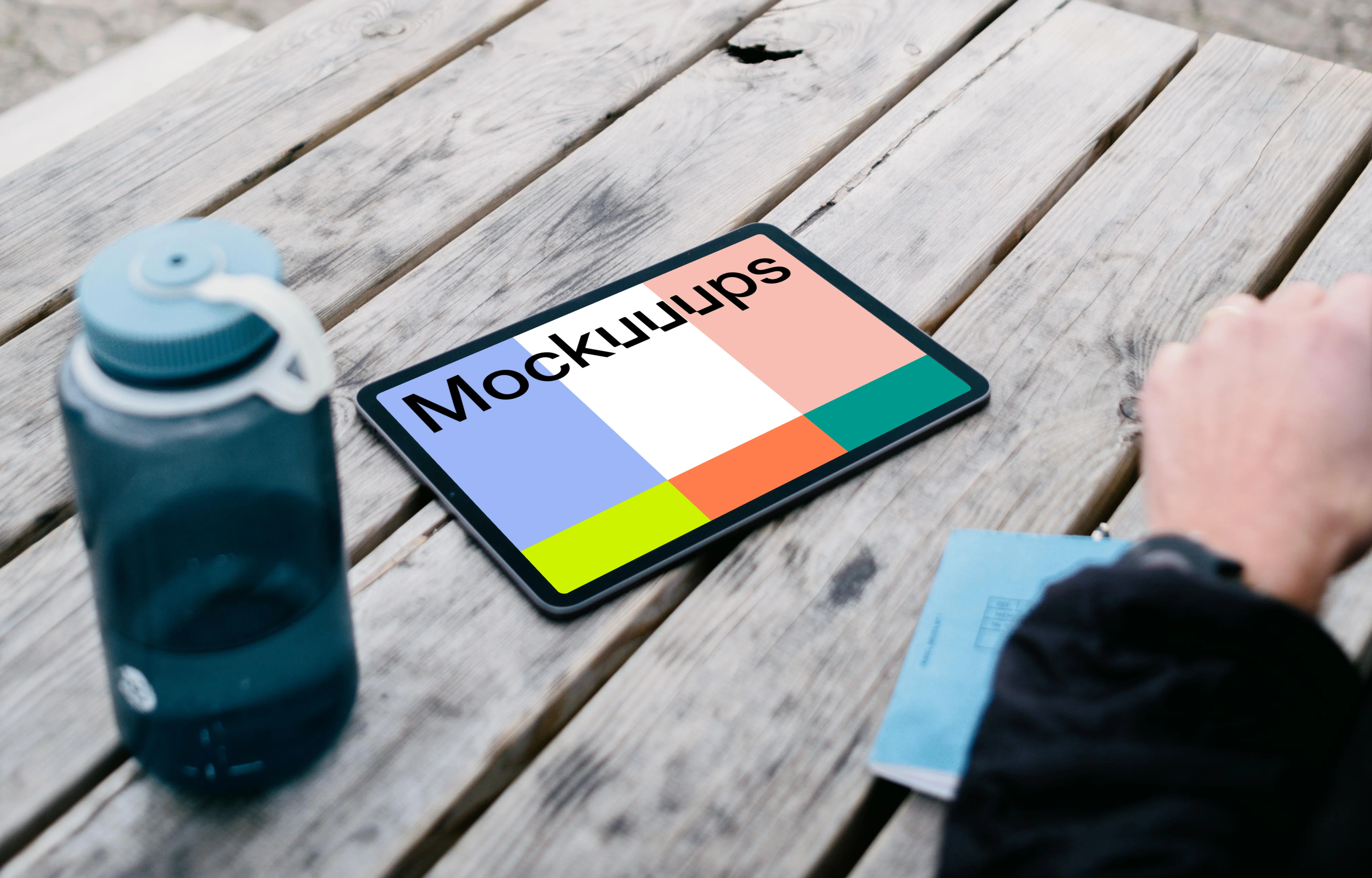 iPad Air mockup on a table with a bottle at the side 