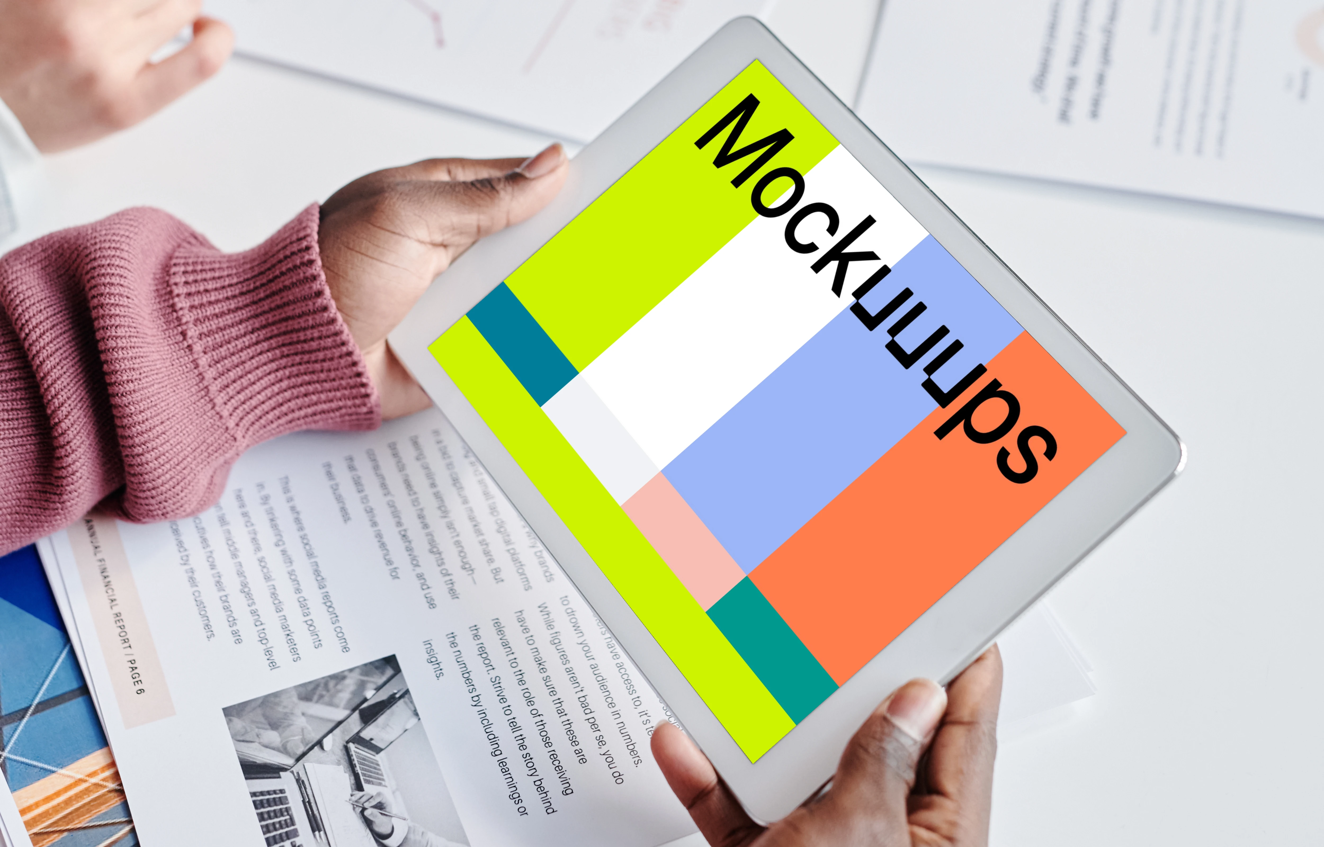 iPad Mini mockup held over a magazine