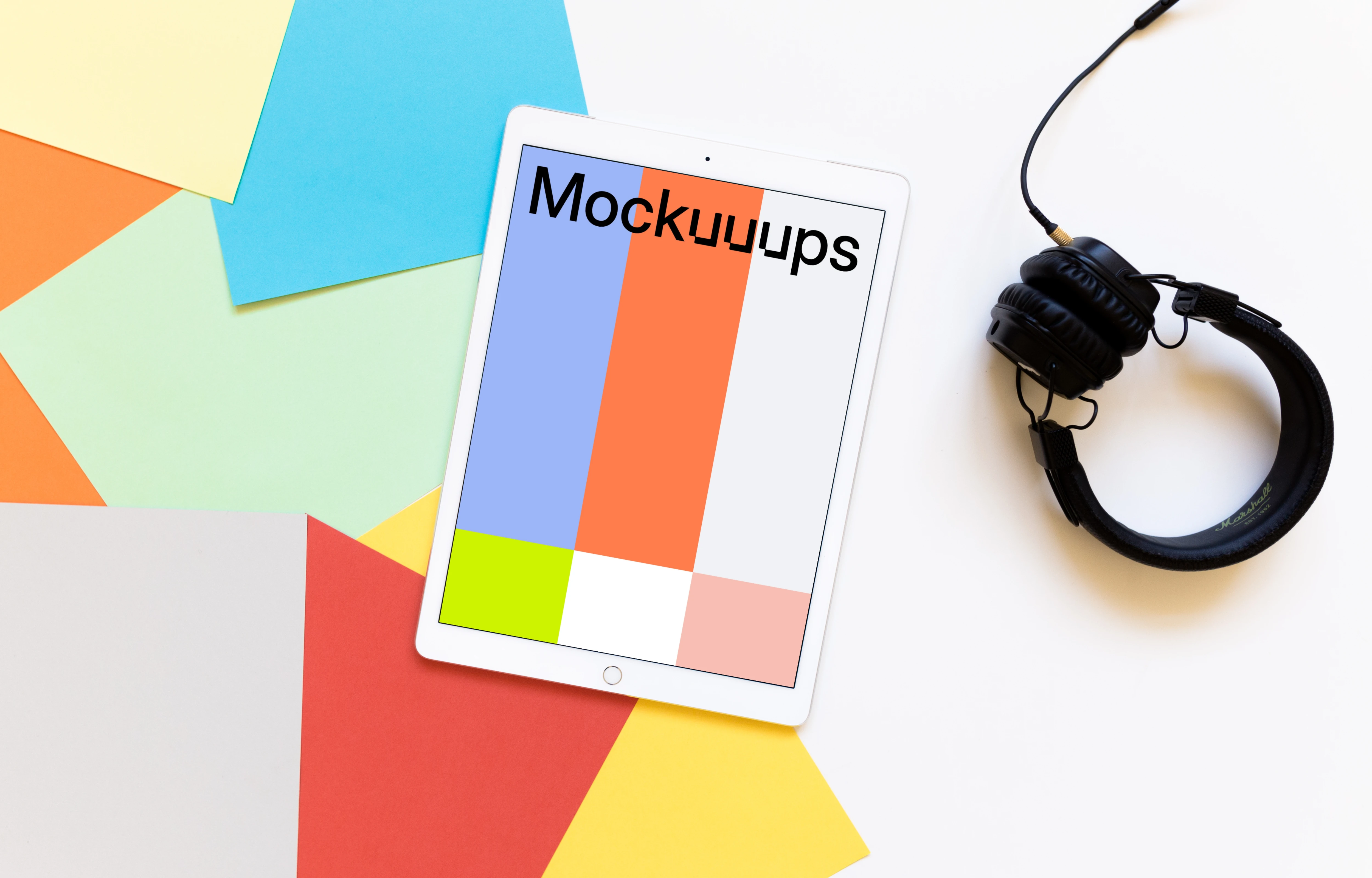 iPad Pro mockup with headphones on light desk