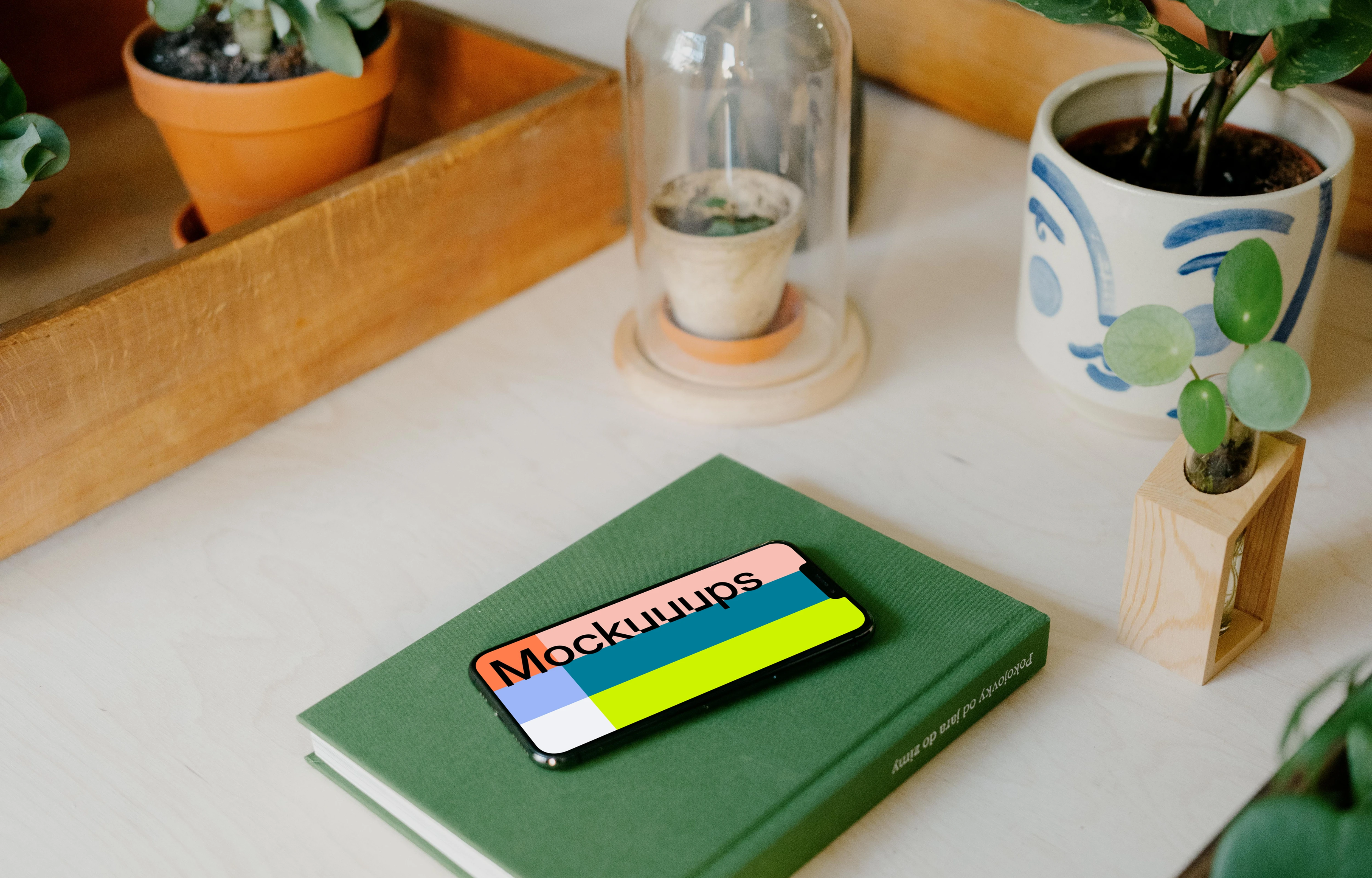 iPhone 13 Pro max mockup on a green notebook