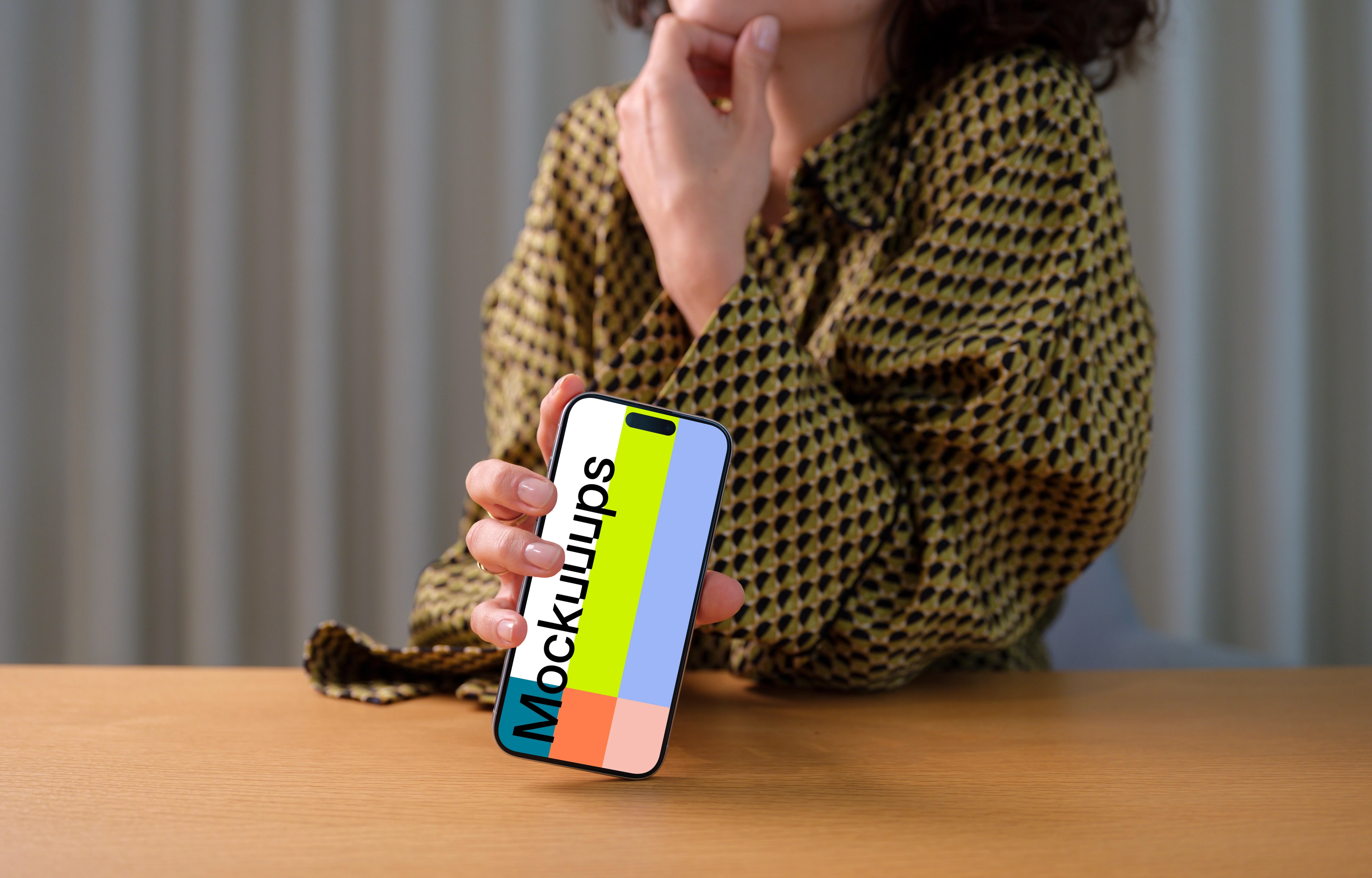 iPhone 15 Pro mockup in a woman's hand with thoughtful pose