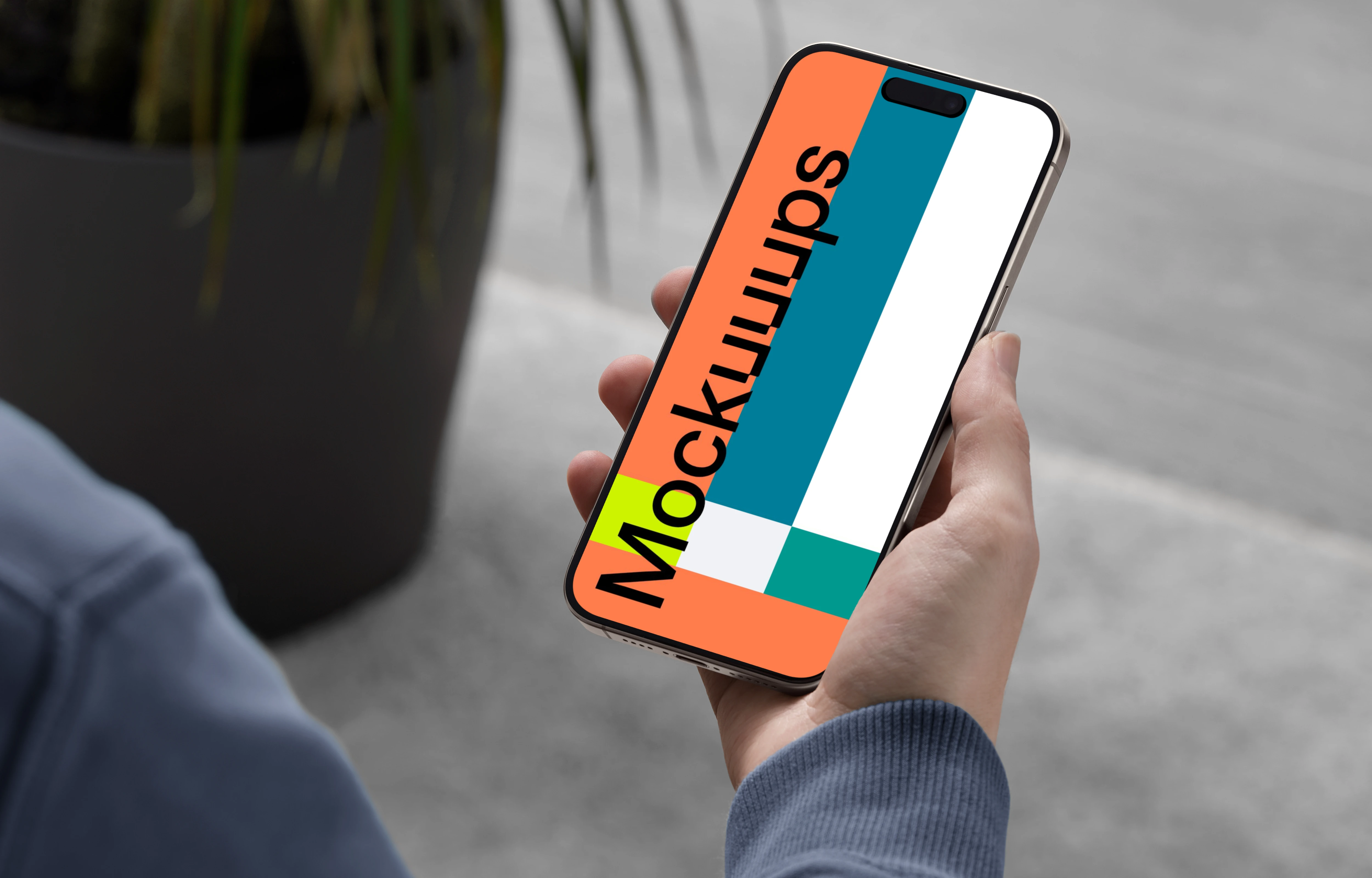 iPhone 15 Pro mockup in male hand with modern decor