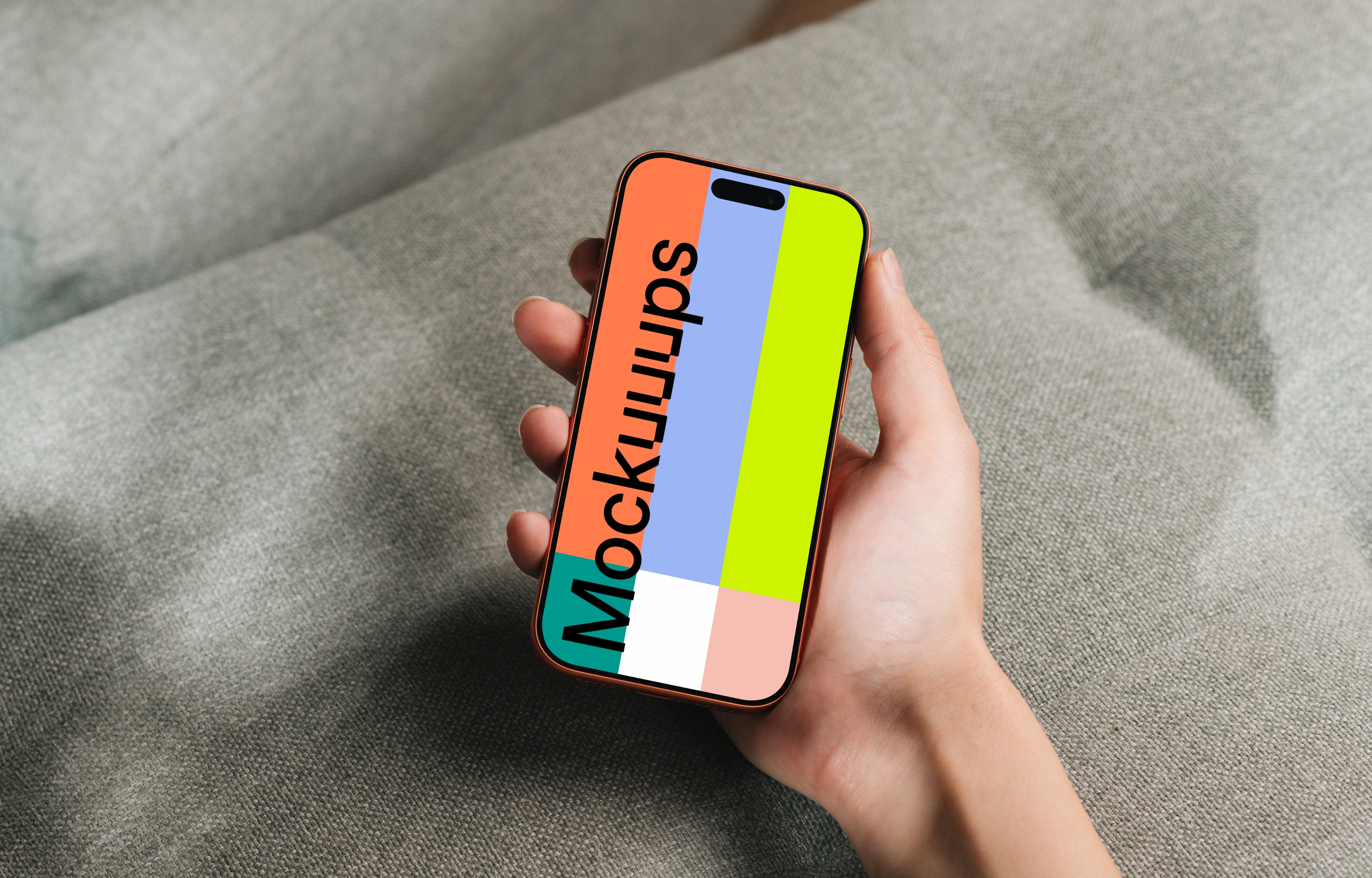 iPhone 17 Pro mockup held over a gray fabric surface