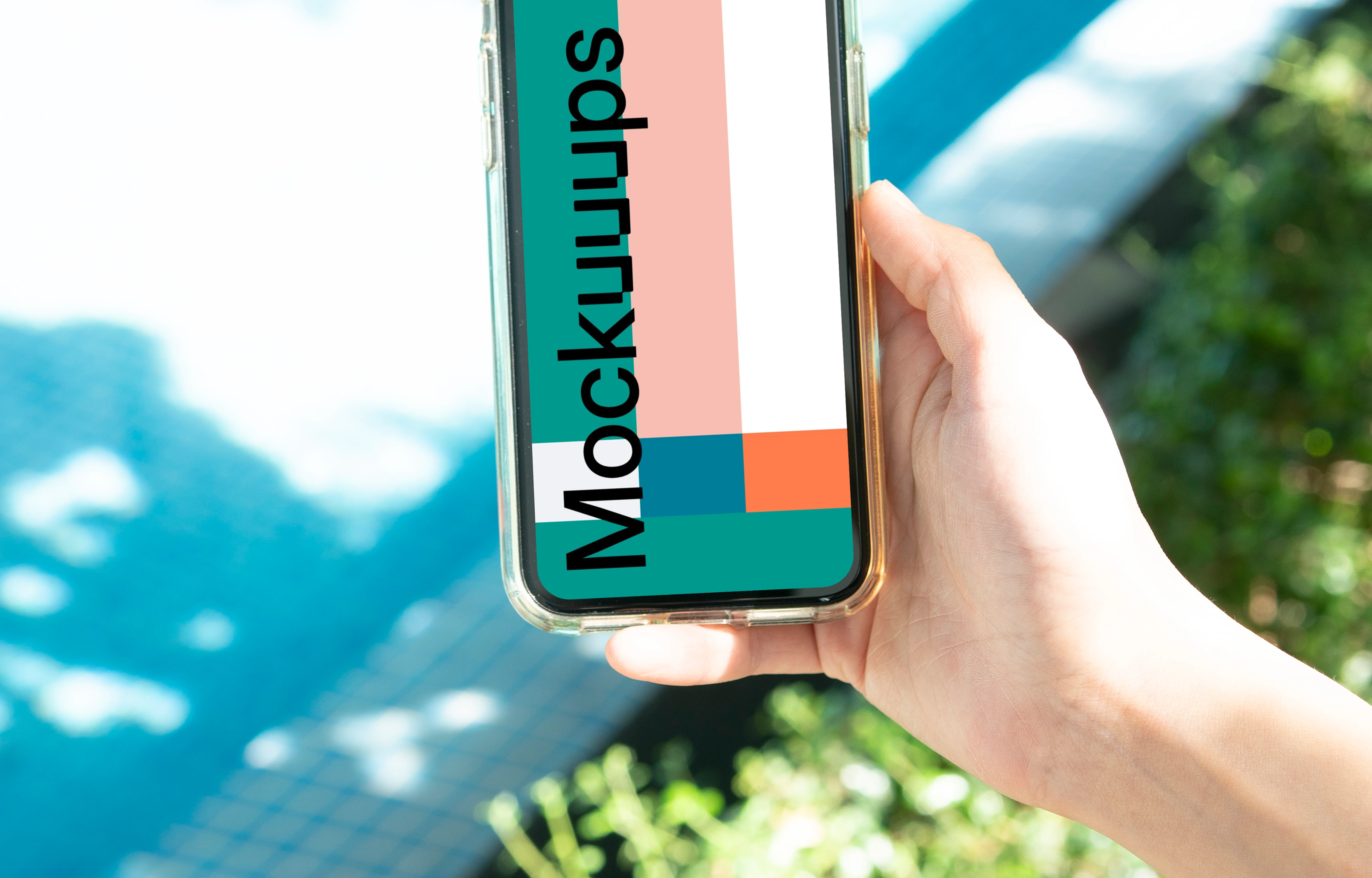 iPhone mockup held by user beside a swimming pool