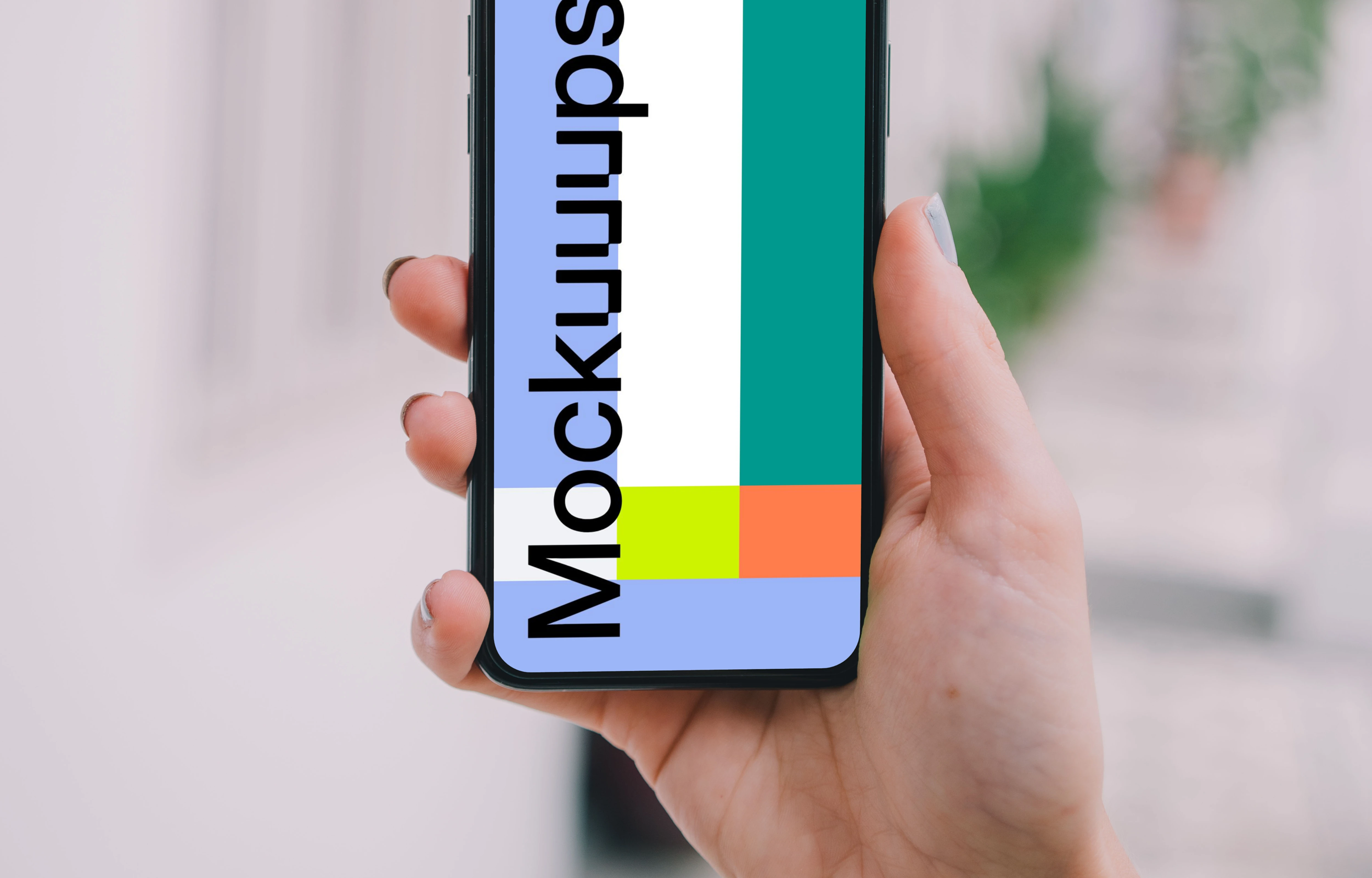 iPhone mockup held up on the street.