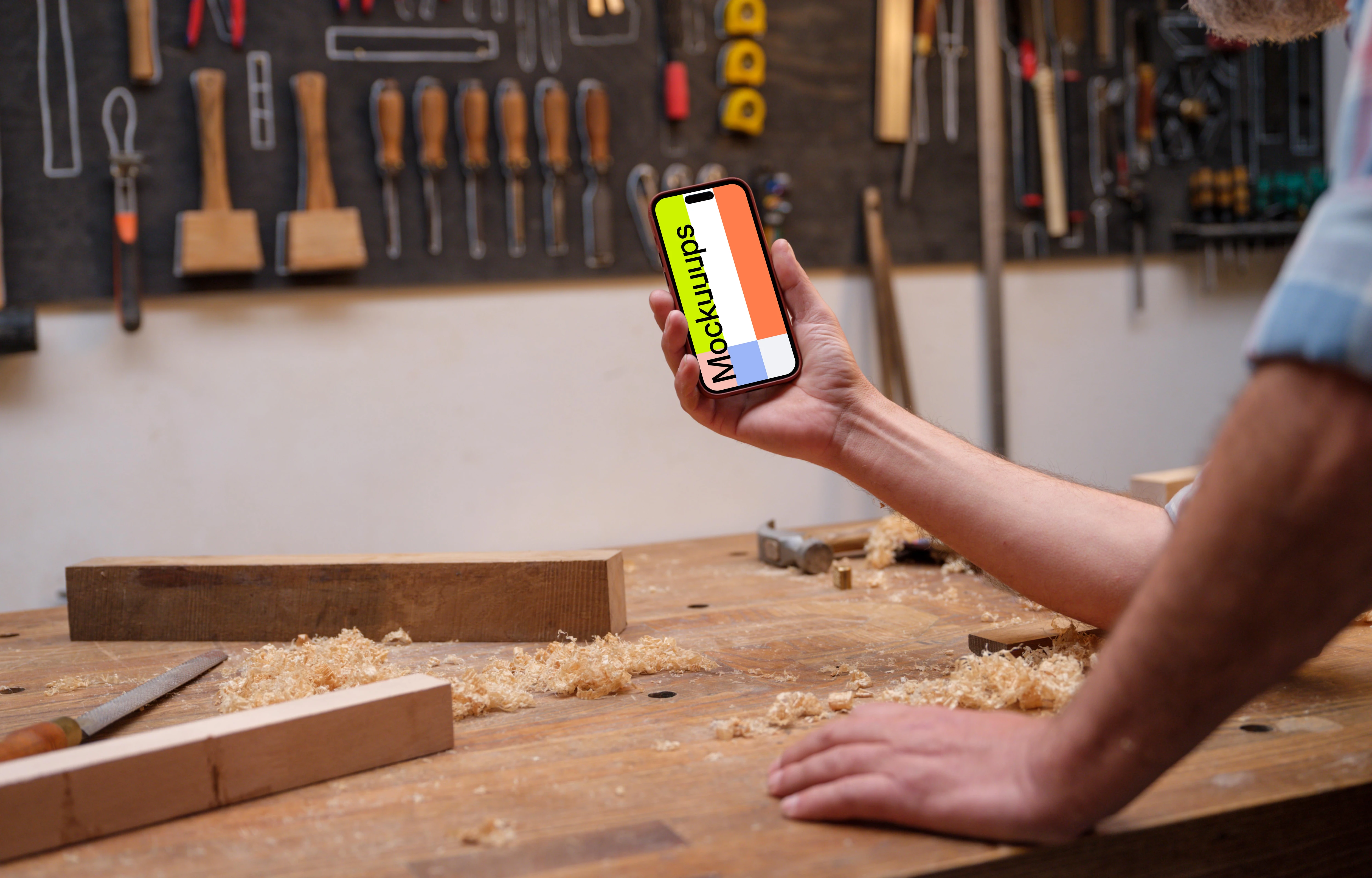 iPhone mockup in carpenter's hand