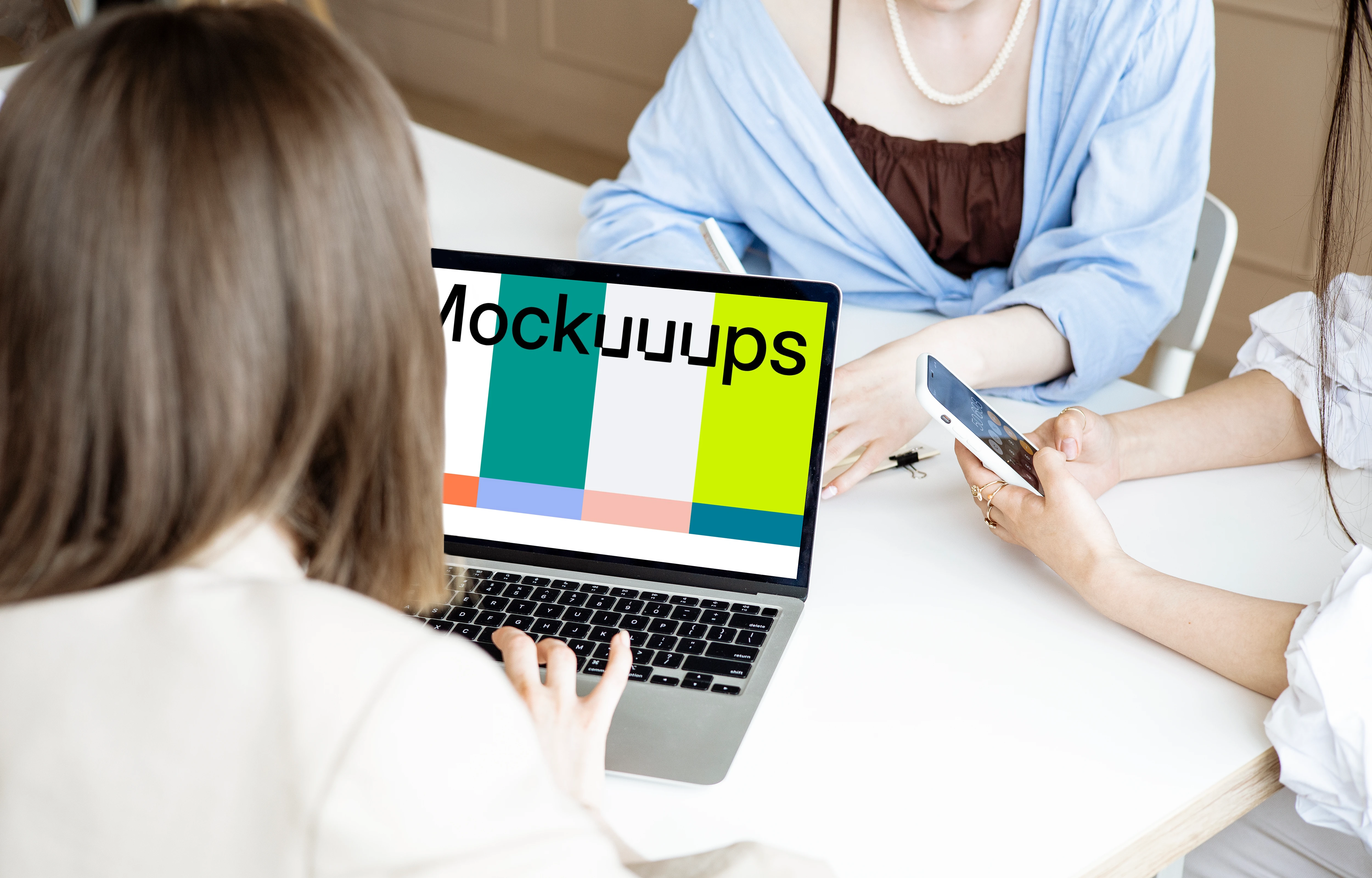 Lady typing on a MacBook Pro mockup in a meeting