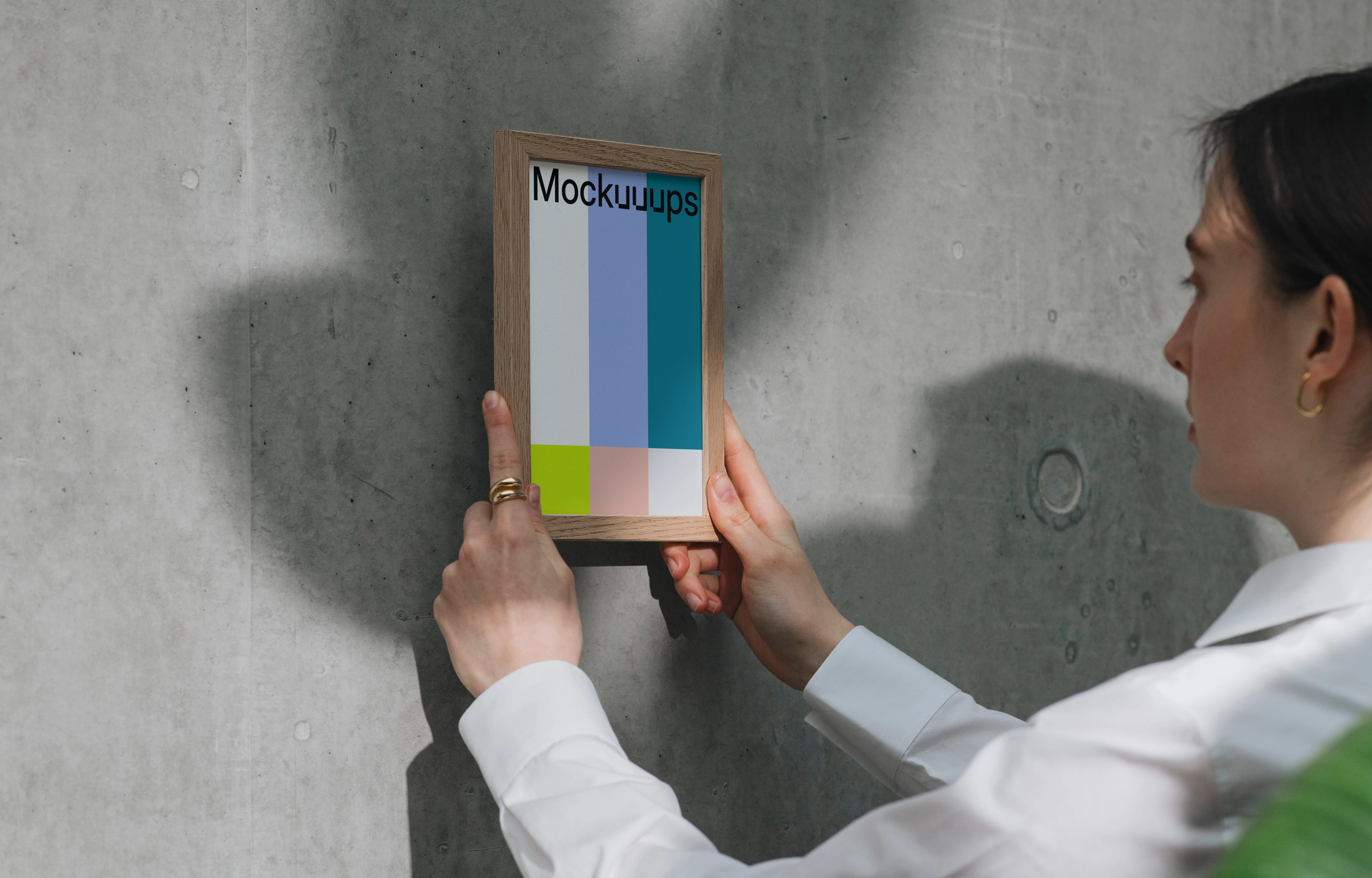 A5 mockup in wooden frame against concrete wall