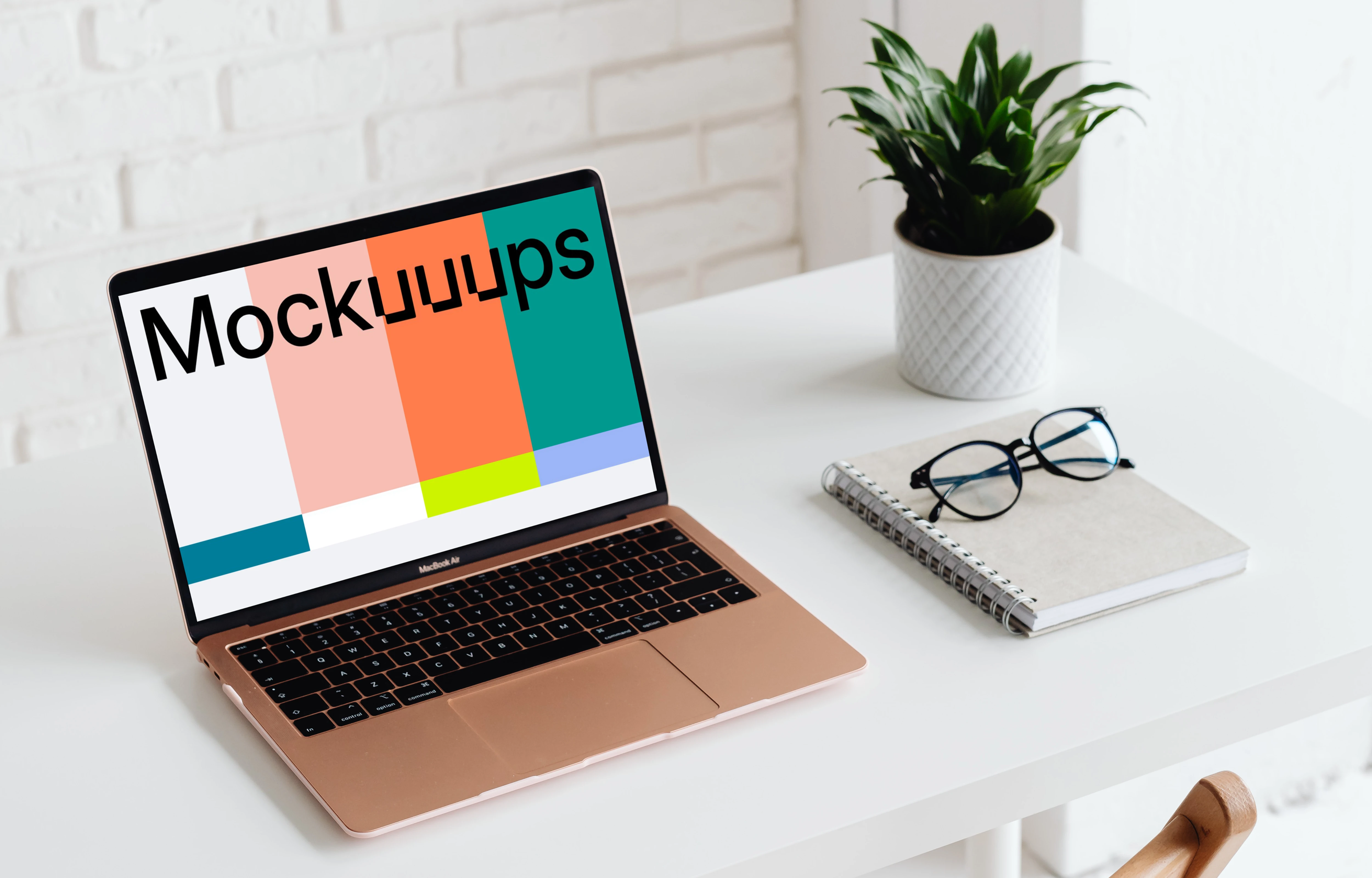 MacBook Air mockup beside a white notebook