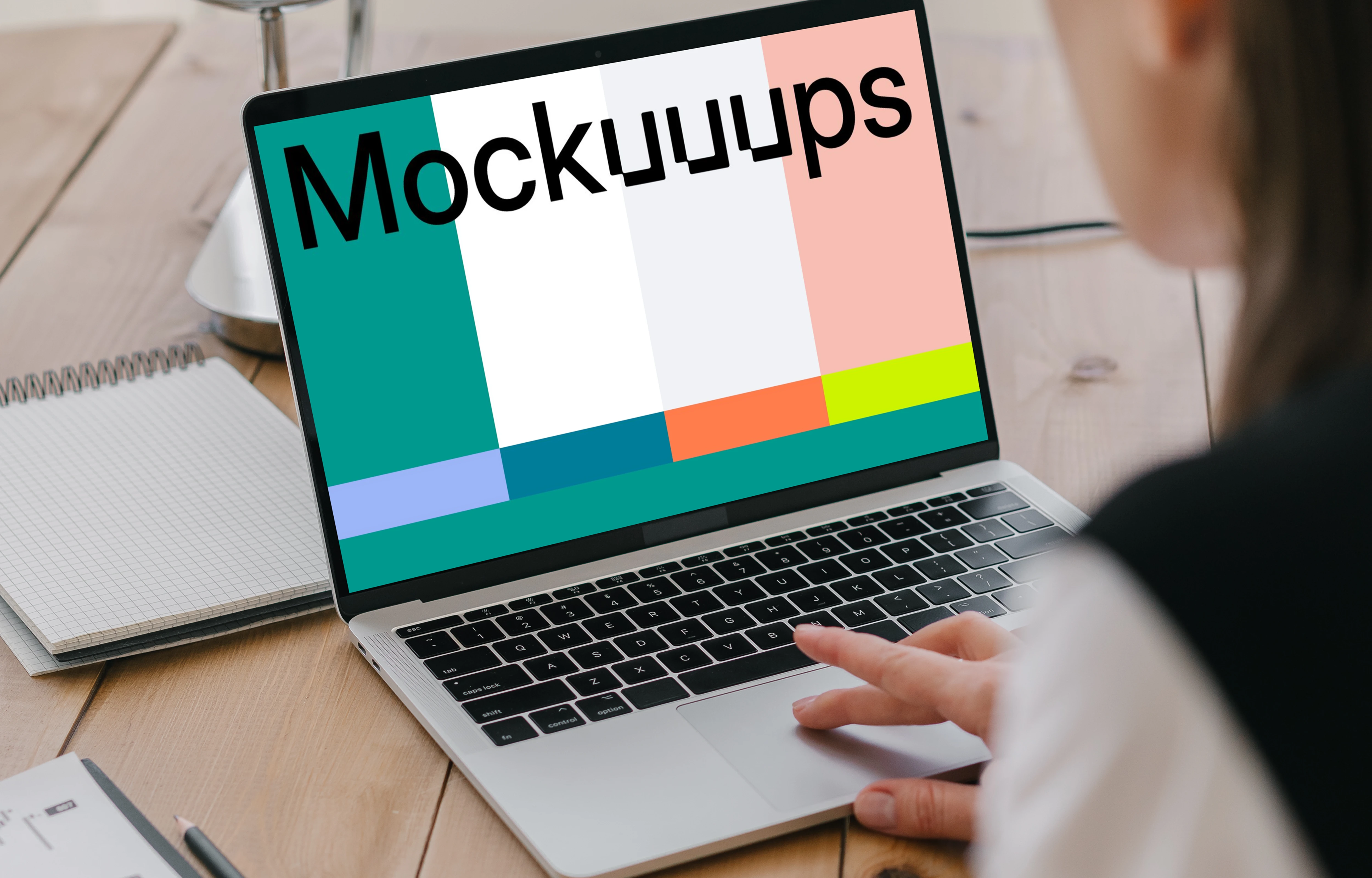 MacBook Air mockup in use by a lady with a notepad at the side