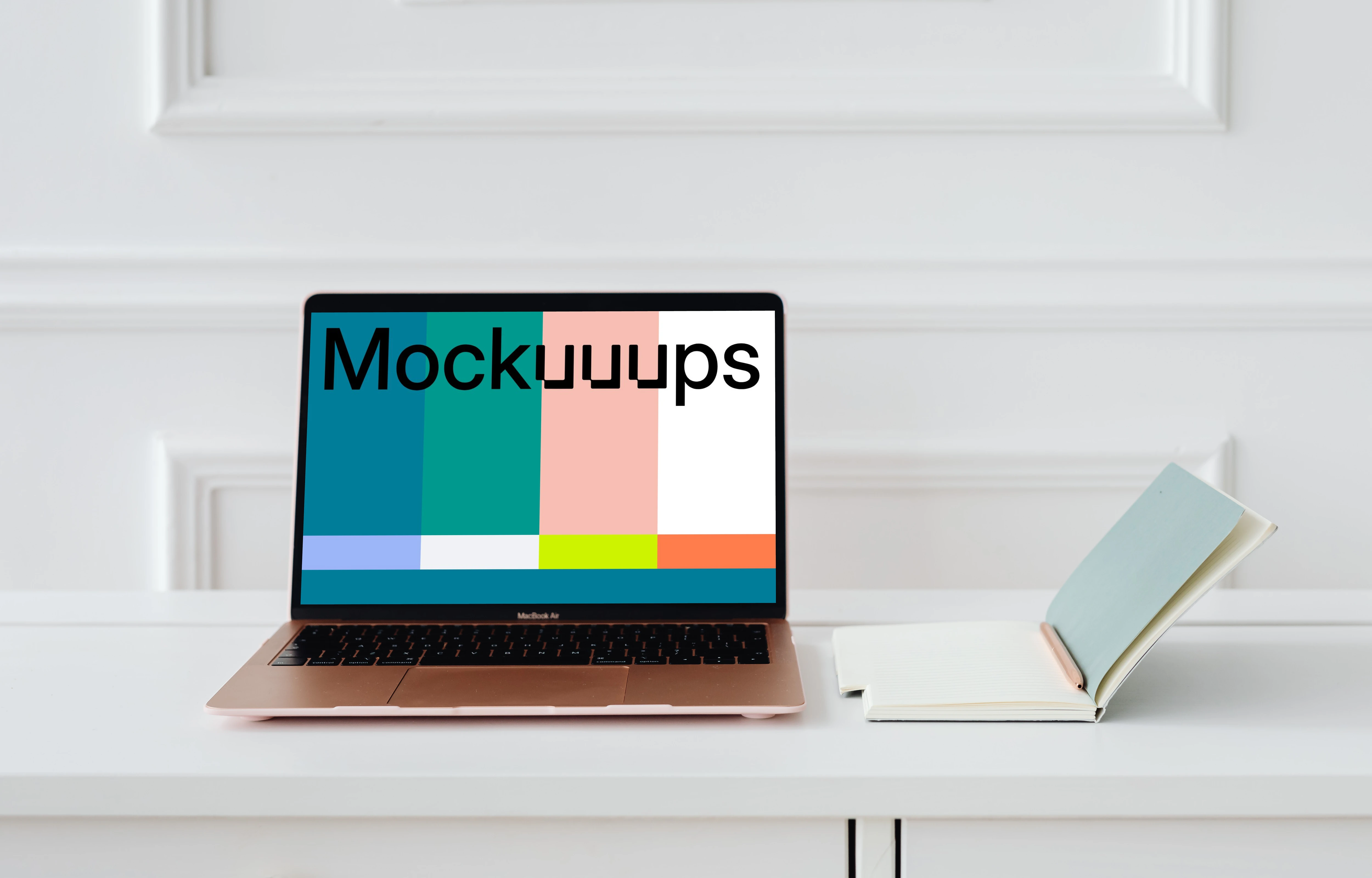 MacBook Air mockup on a table beside a notepad and a pencil