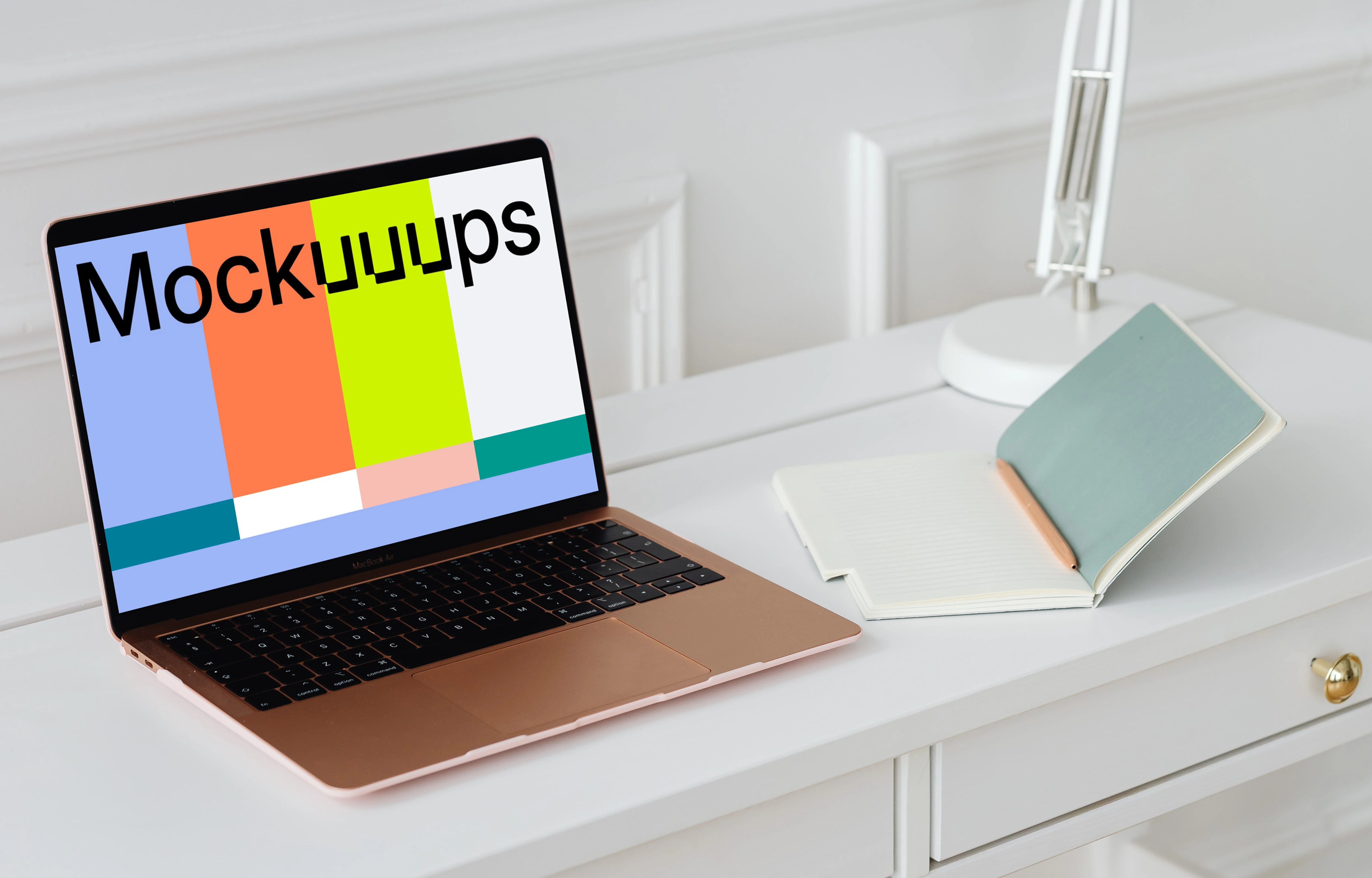 MacBook Air mockup on a table beside an open notepad  