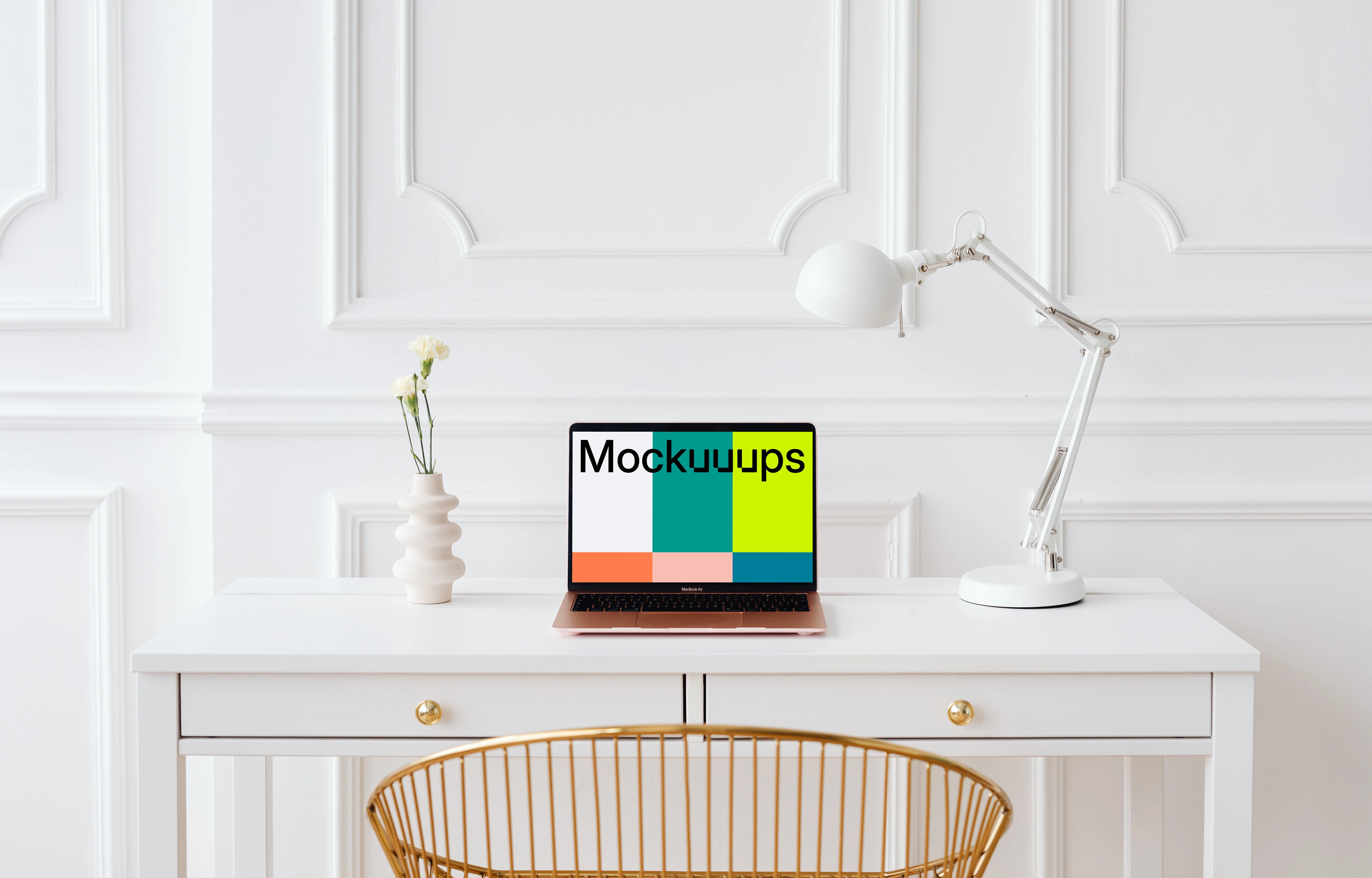 MacBook Air mockup on a table with a plant vase at the side