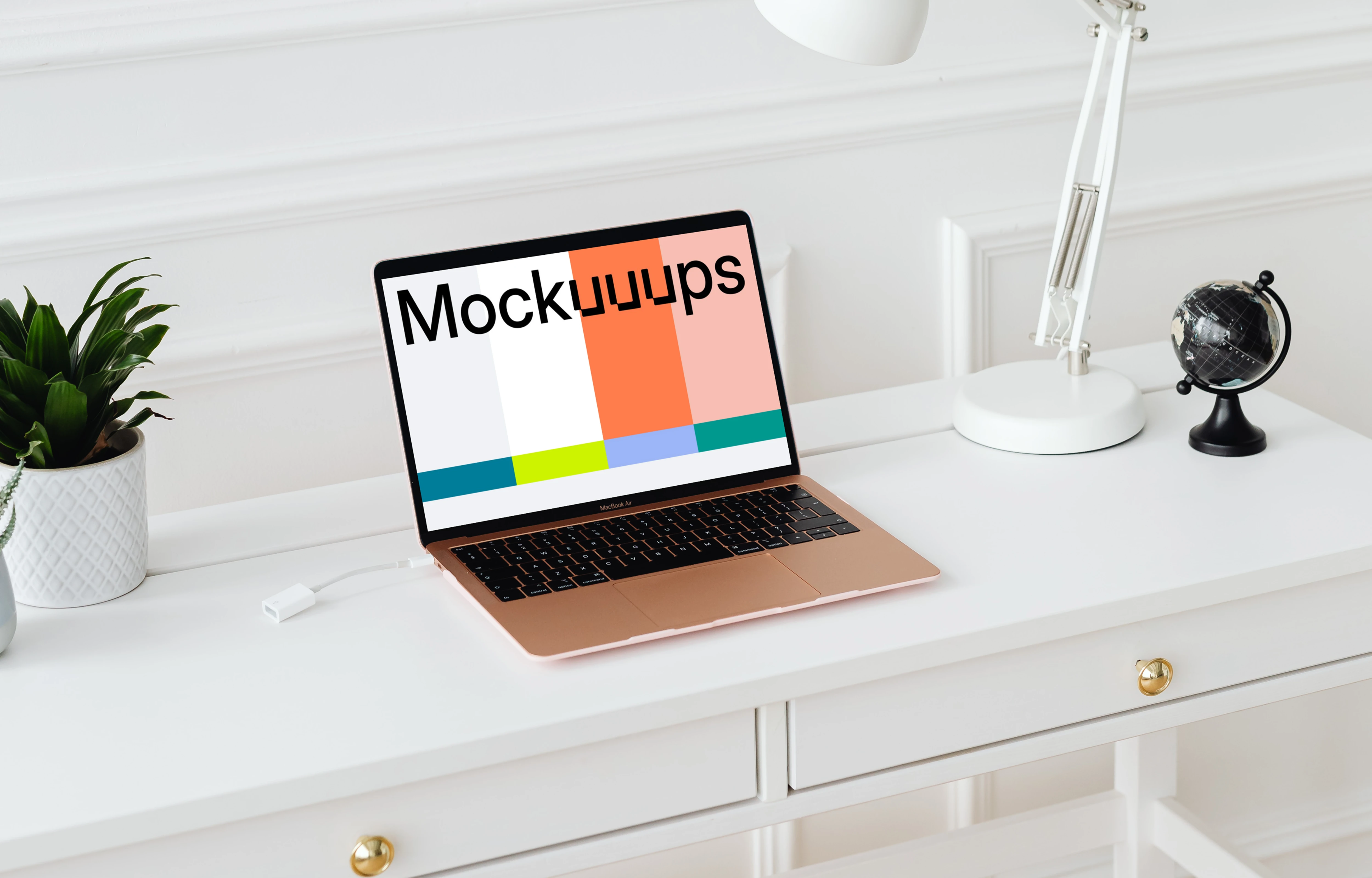 MacBook Air mockup on a white table beside a potted plant