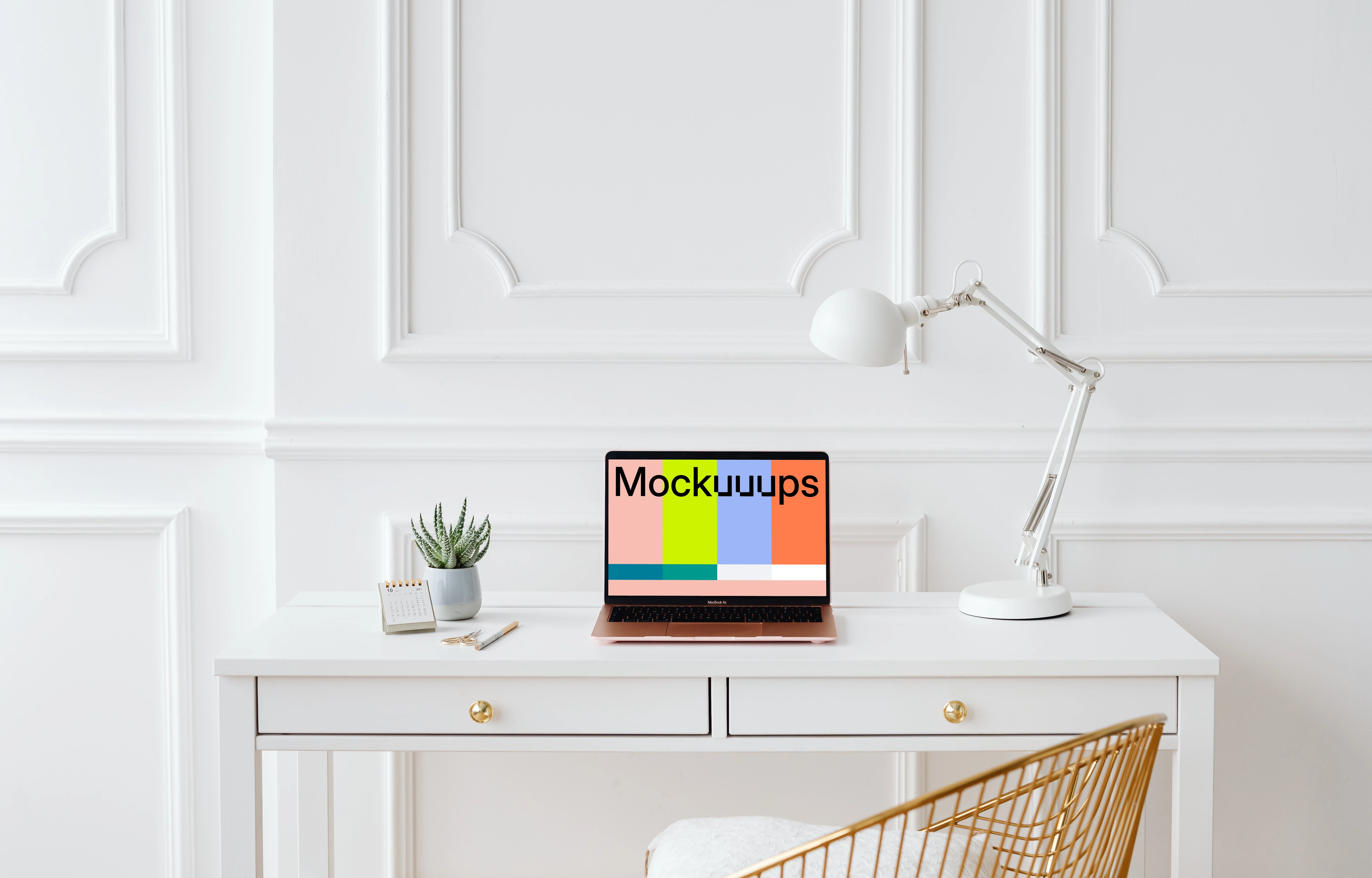 MacBook Air mockup with a white reading lamp at its side.