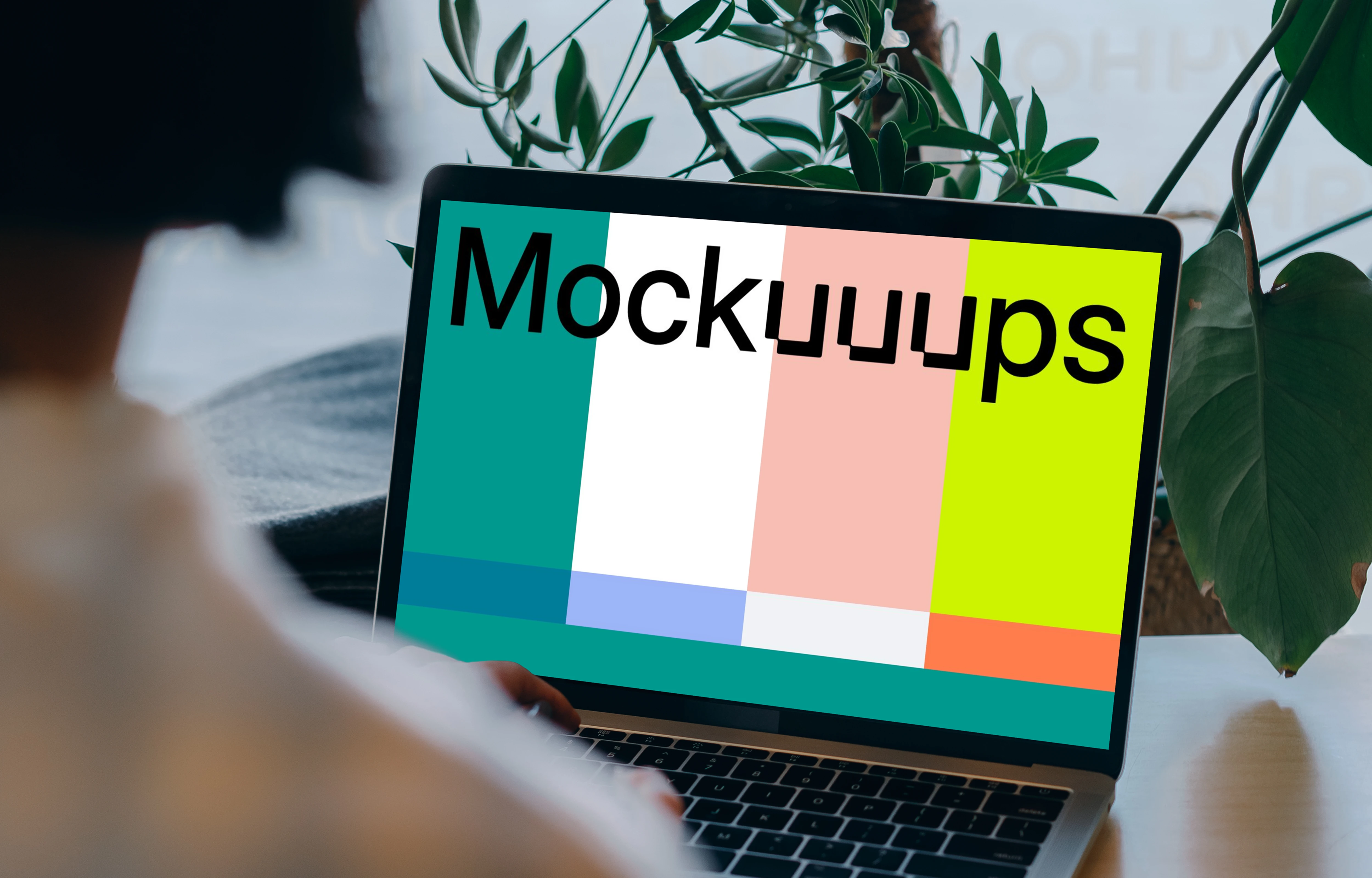 MacBook mockup in front of a user with plants in the background