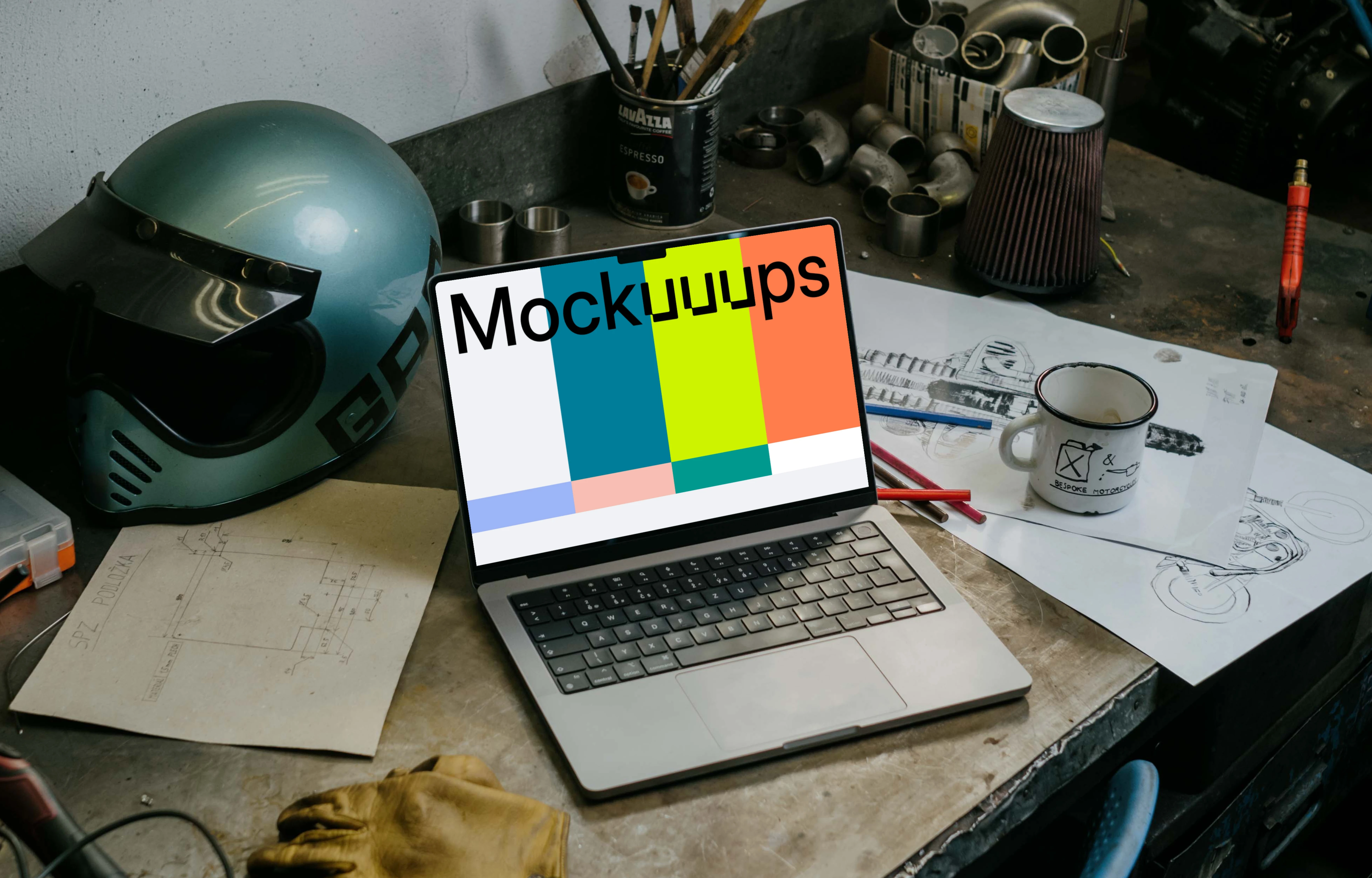 MacBook Pro mockup beside a motorcylce helmet