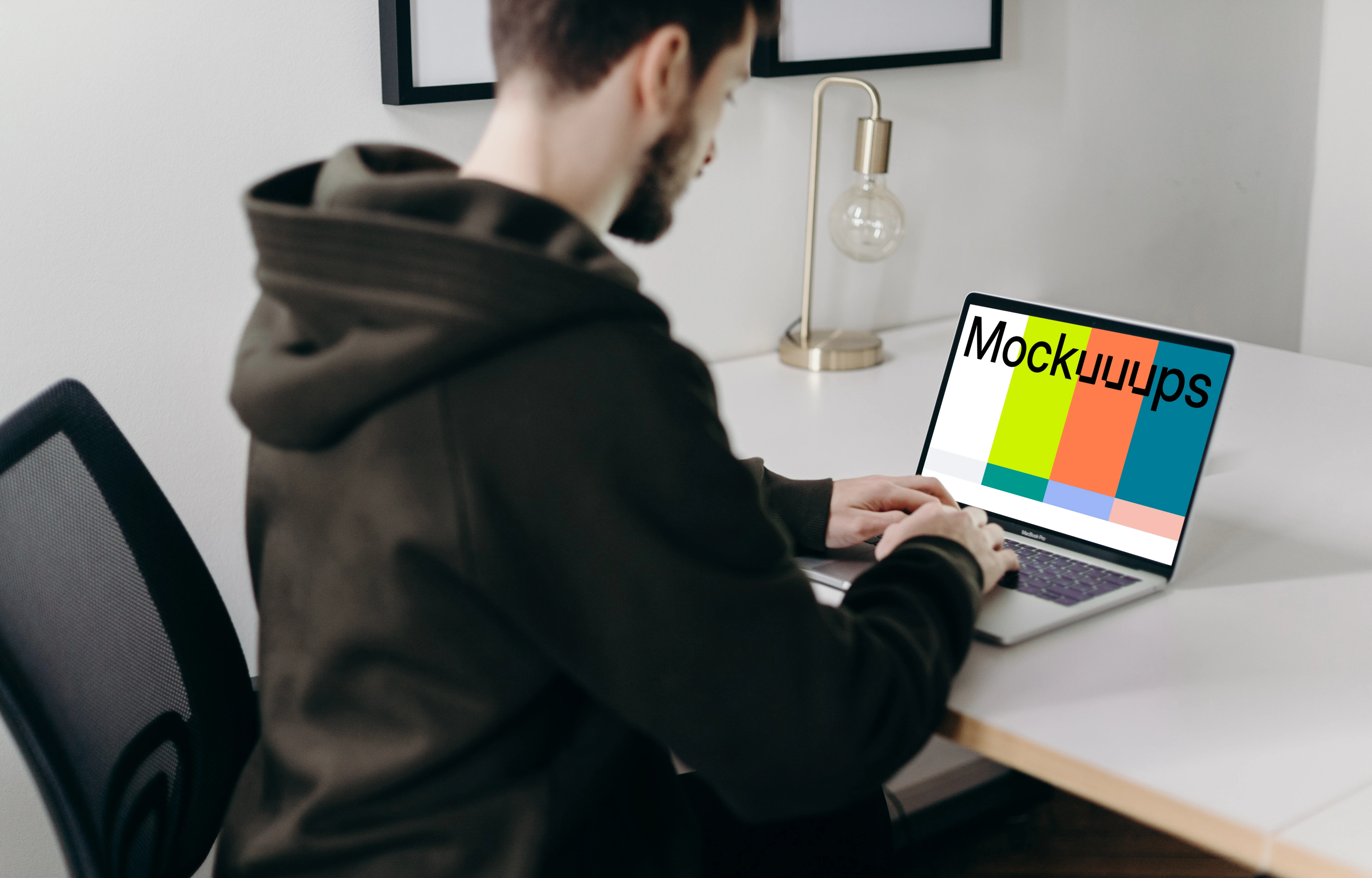 MacBook Pro mockup on a white table close to a lamp