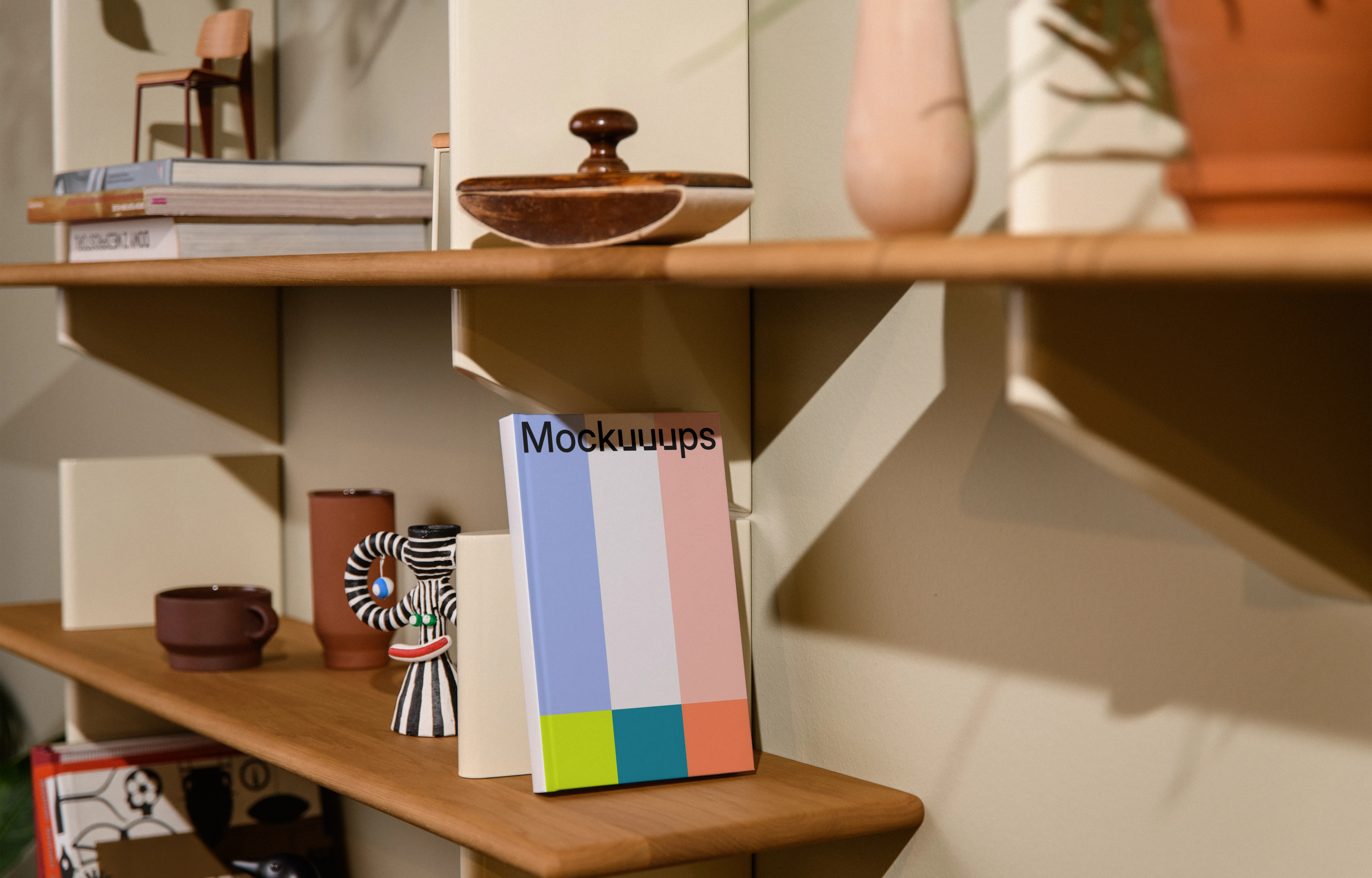 Mockup of a C-format book on a wooden shelf with decor