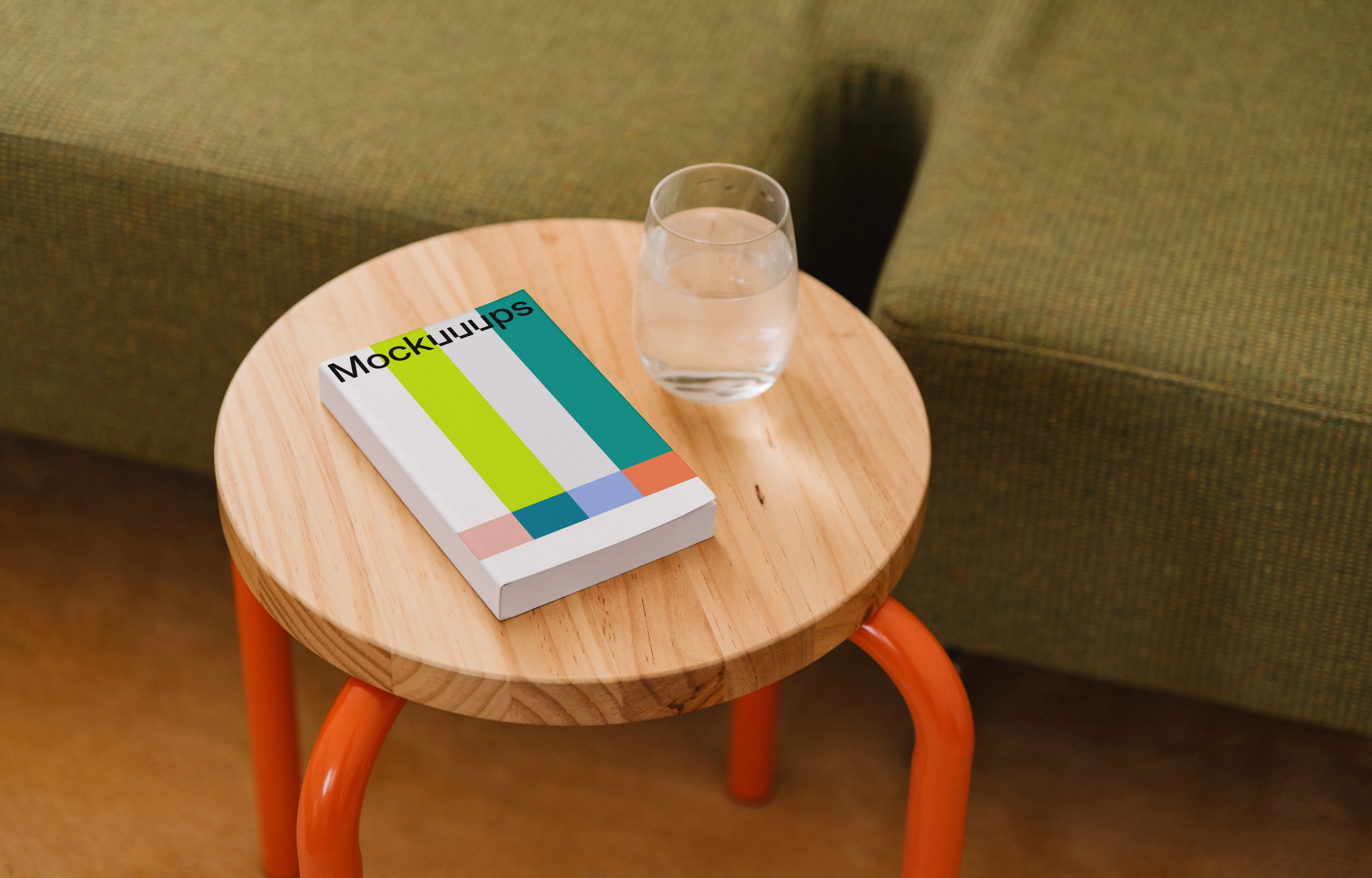 Mockup of a softcover book on a wooden side table
