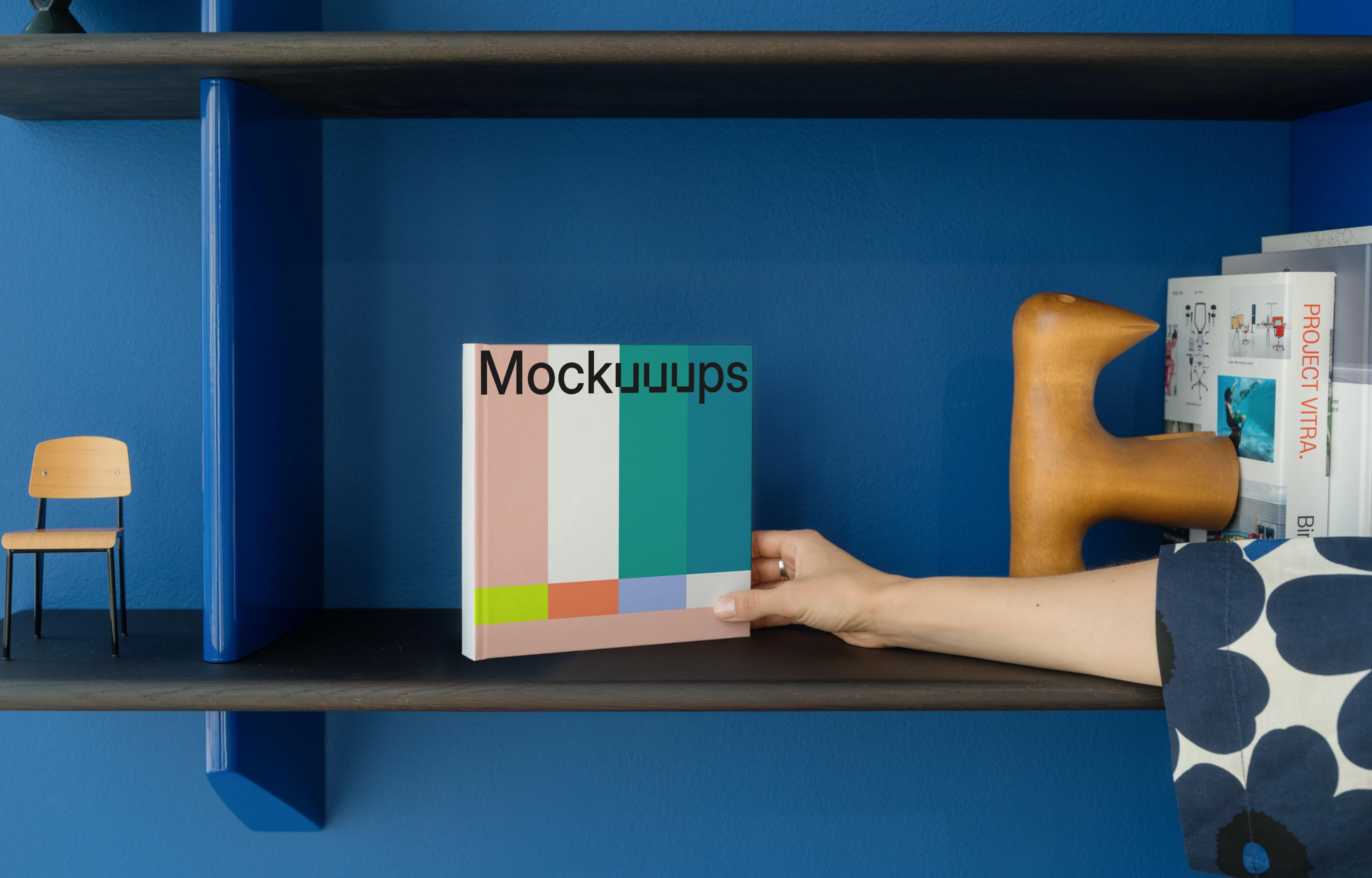 Mockup of a square book on a colorful shelf