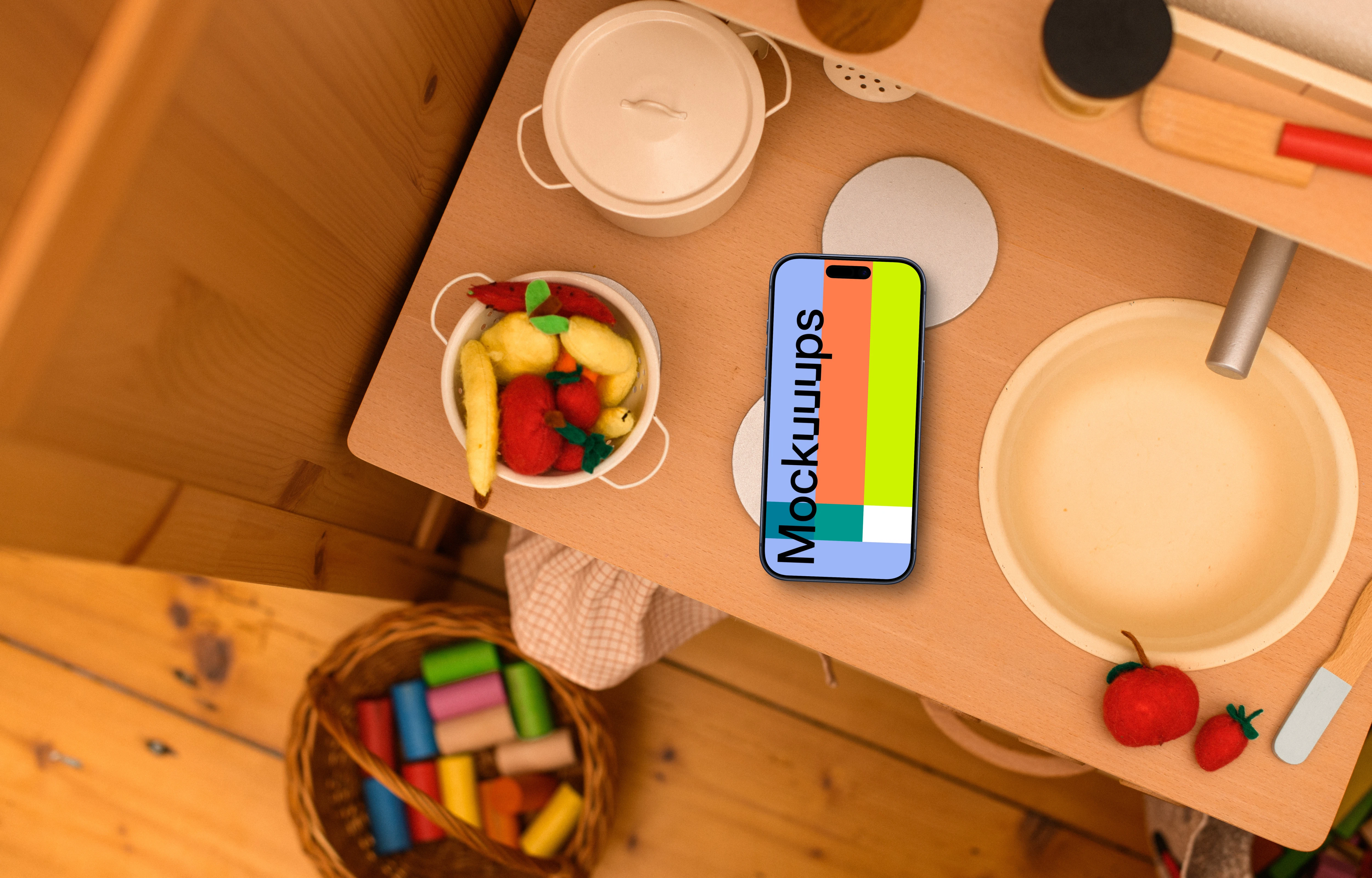 Smartphone mockup on a kid's creative table