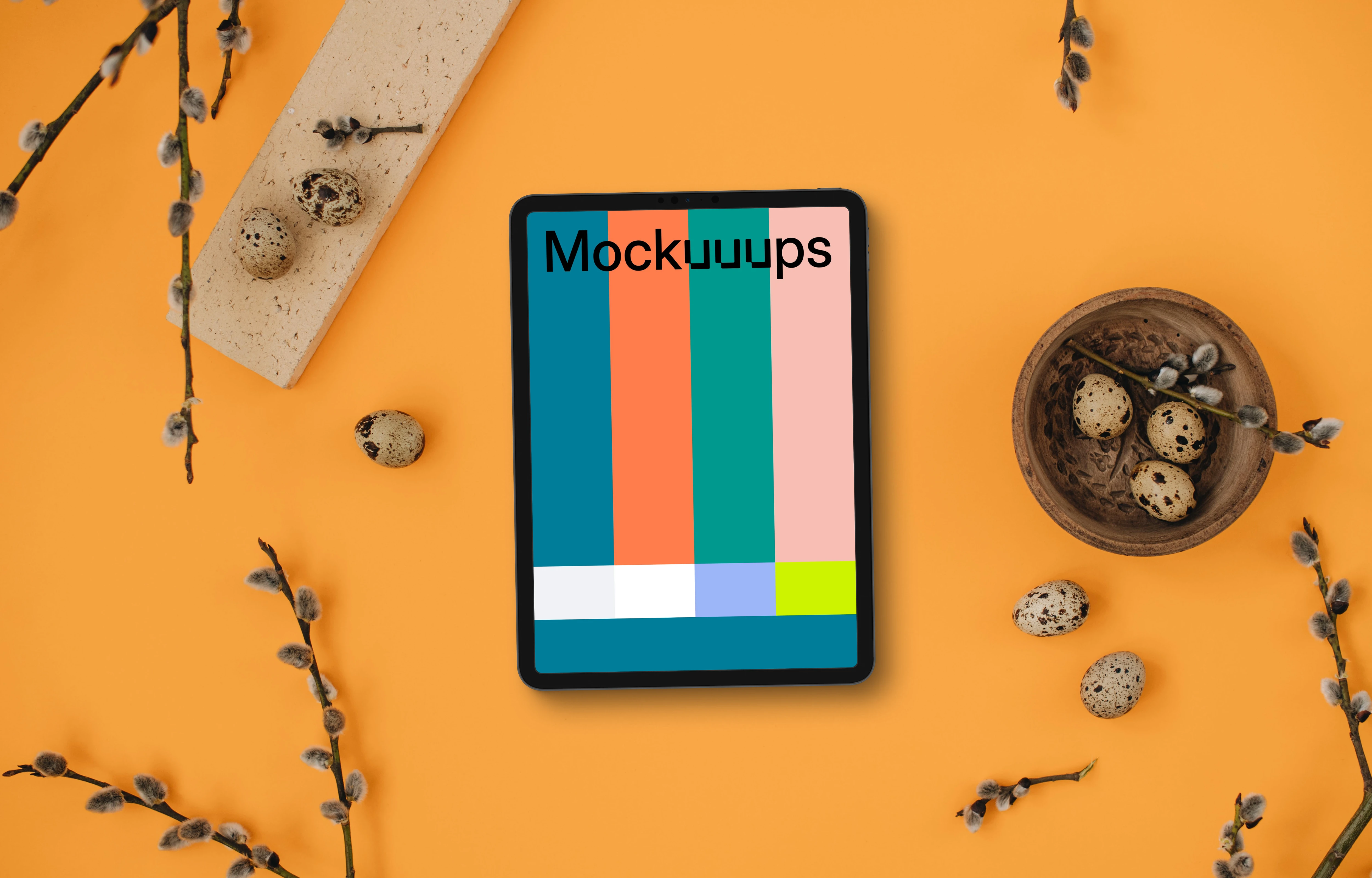Orange table with a tablet mockup and Easter decorations