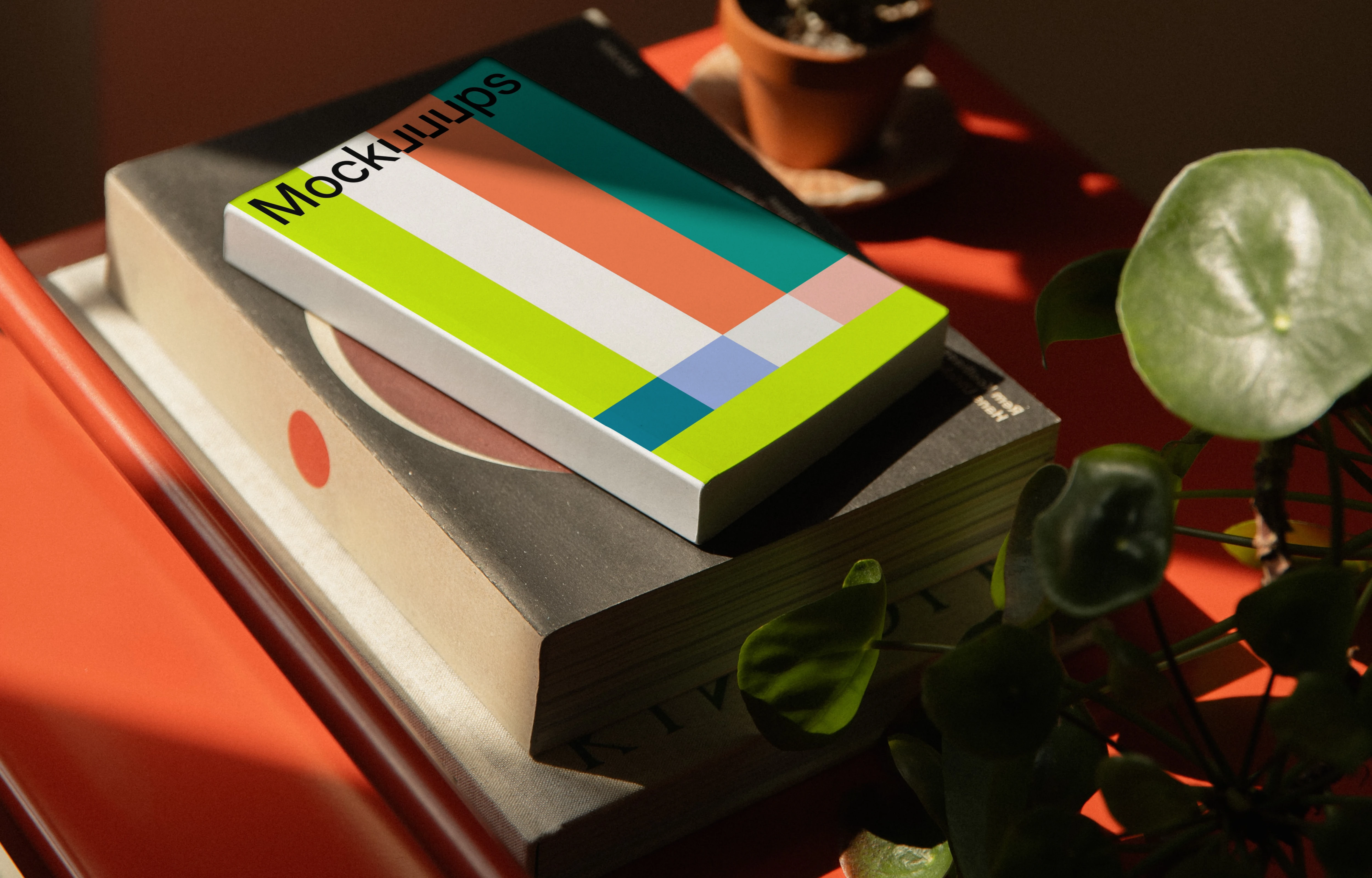 Paperback mockup on a red metal shelf with plants