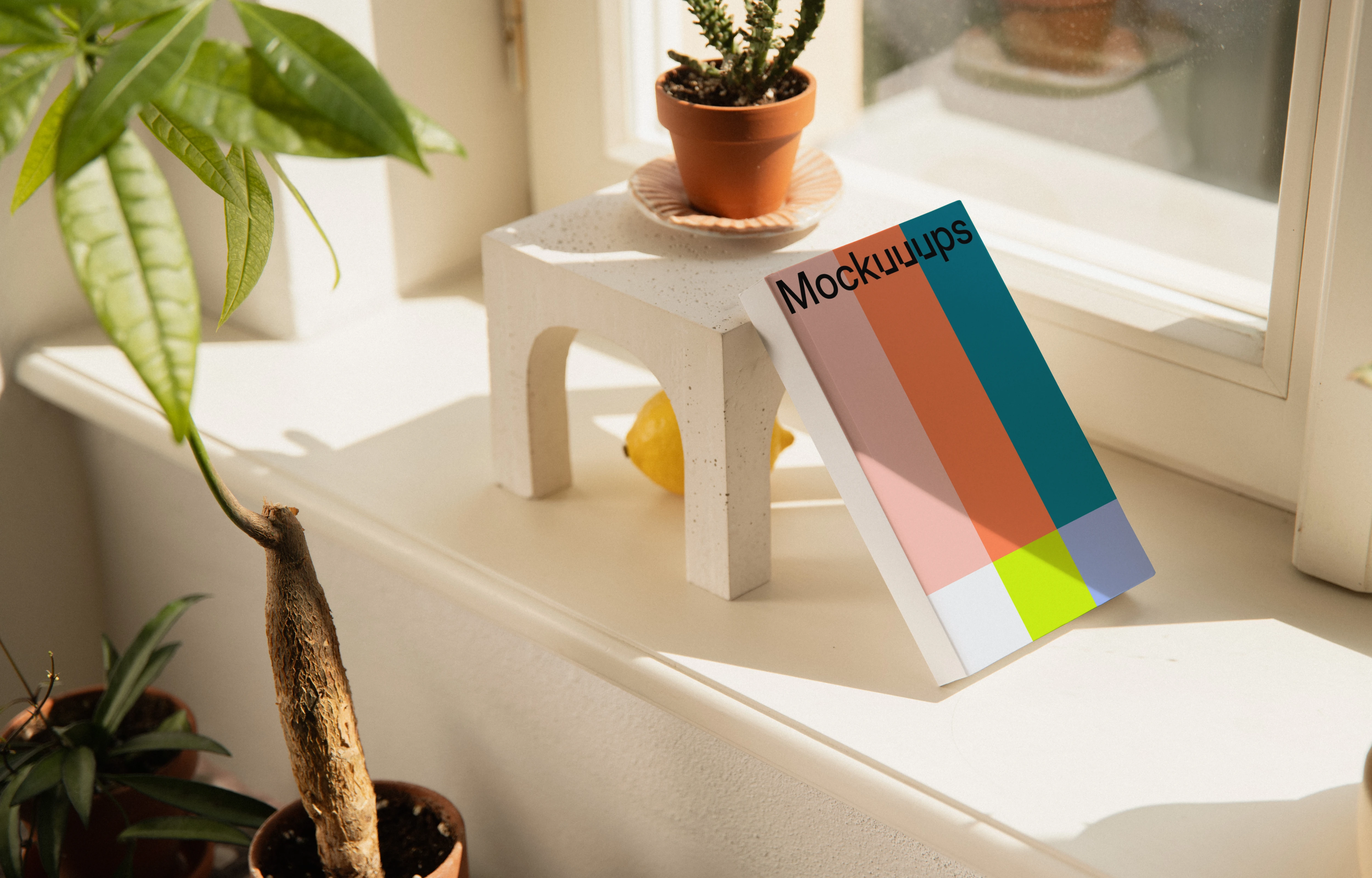 Paperback mockup on a sunny windowsill with plants