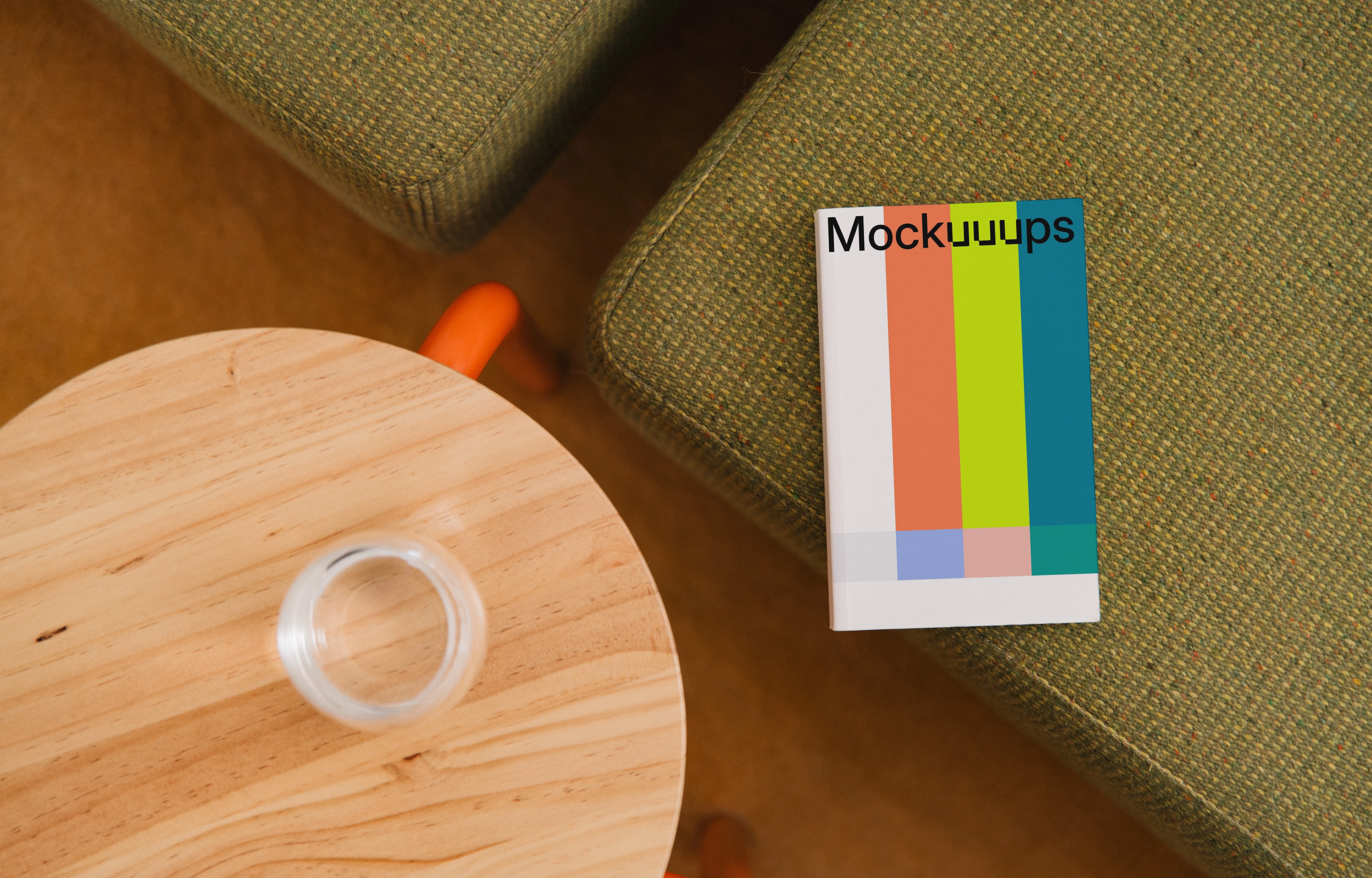 Paperback mockup on a textured sofa and wooden table