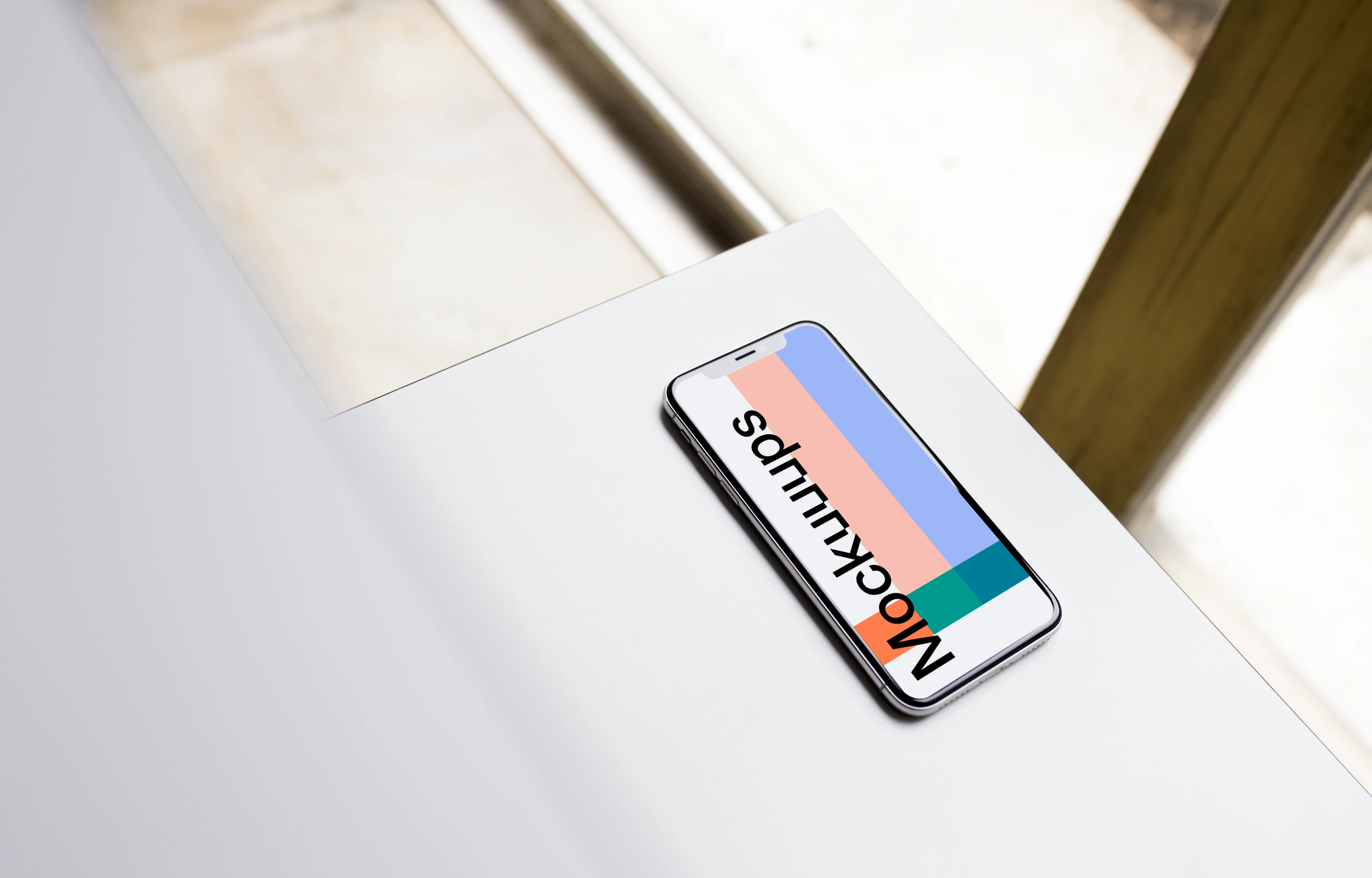 Angle view of iPhone X mockup on the table