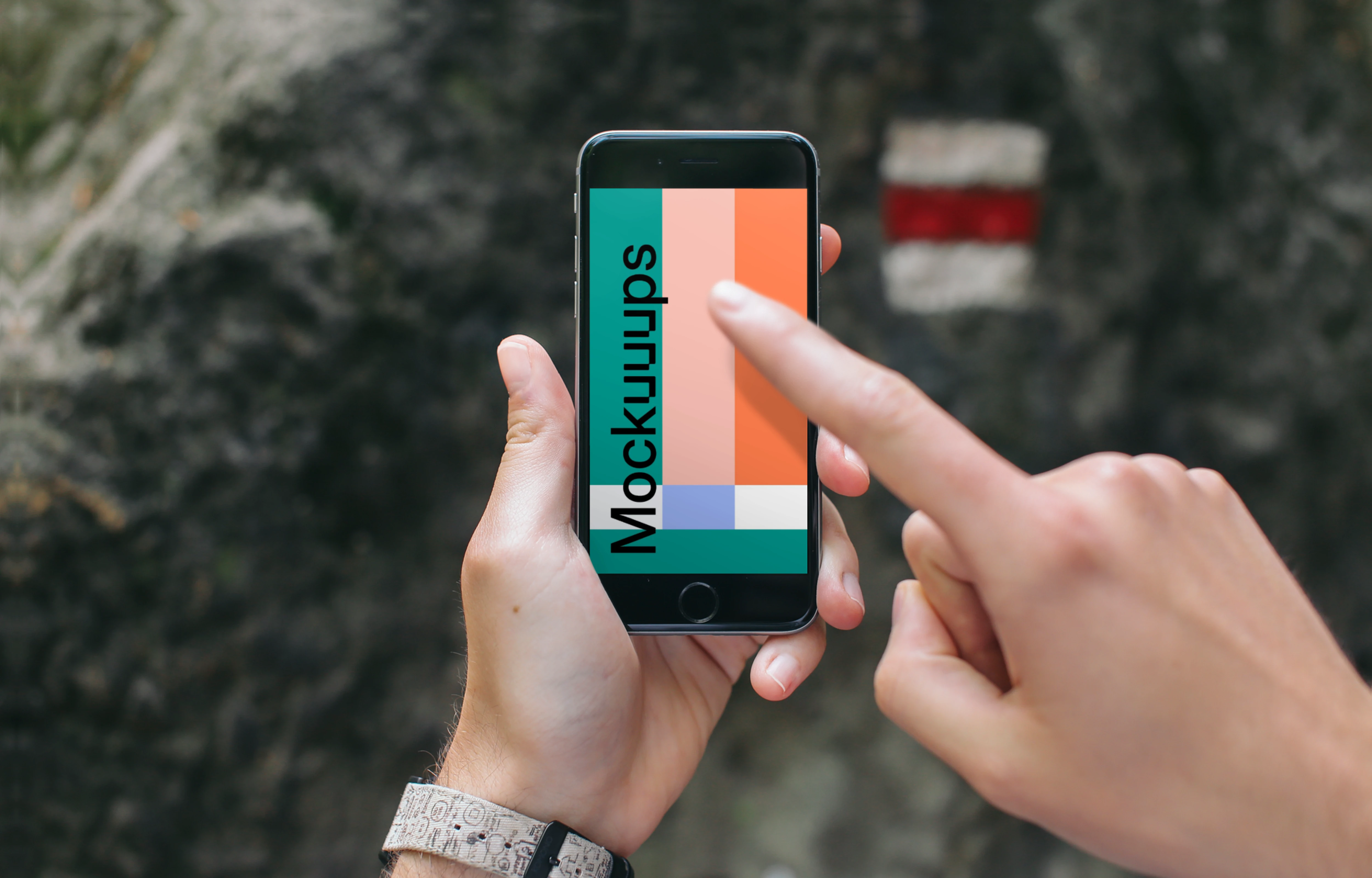 Pointing on iPhone 6 mockup in mountains